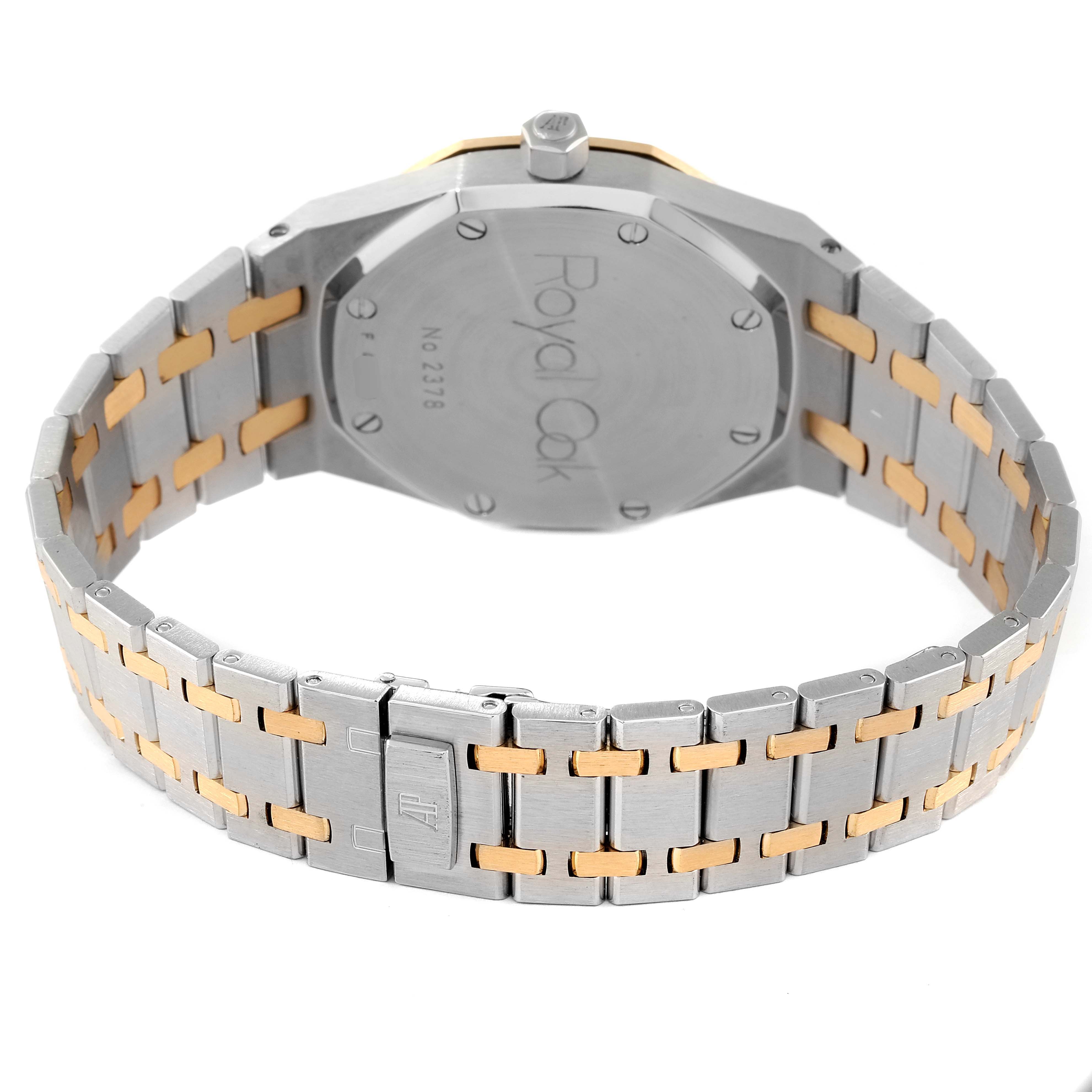 The image shows the back case and bracelet of a Royal Oak model by Audemars Piguet, highlighting the two-tone metal design.