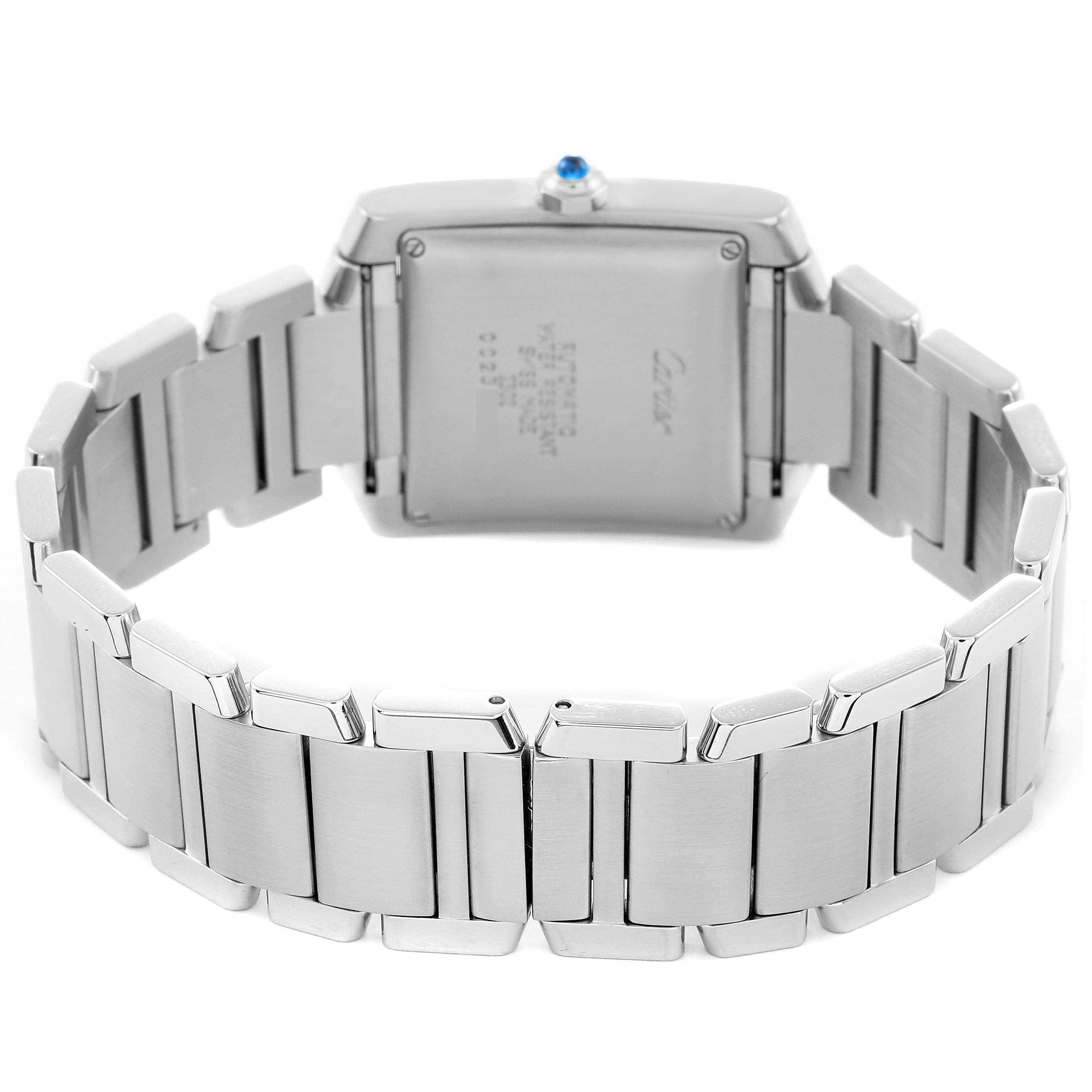 The Cartier Tank Française is shown from the back, highlighting its metal bracelet and case with an engraved case back.