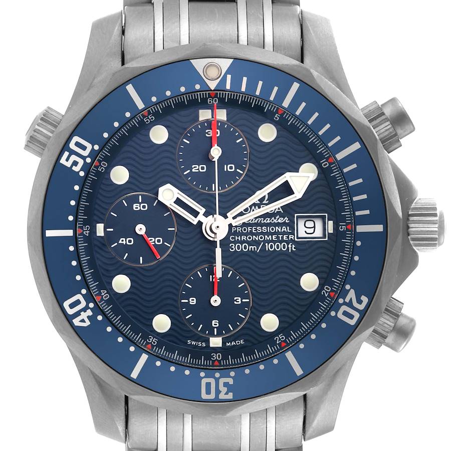 The image shows a front view of an Omega Seamaster watch, displaying its blue dial, chronograph subdials, date window, and stainless steel bracelet.