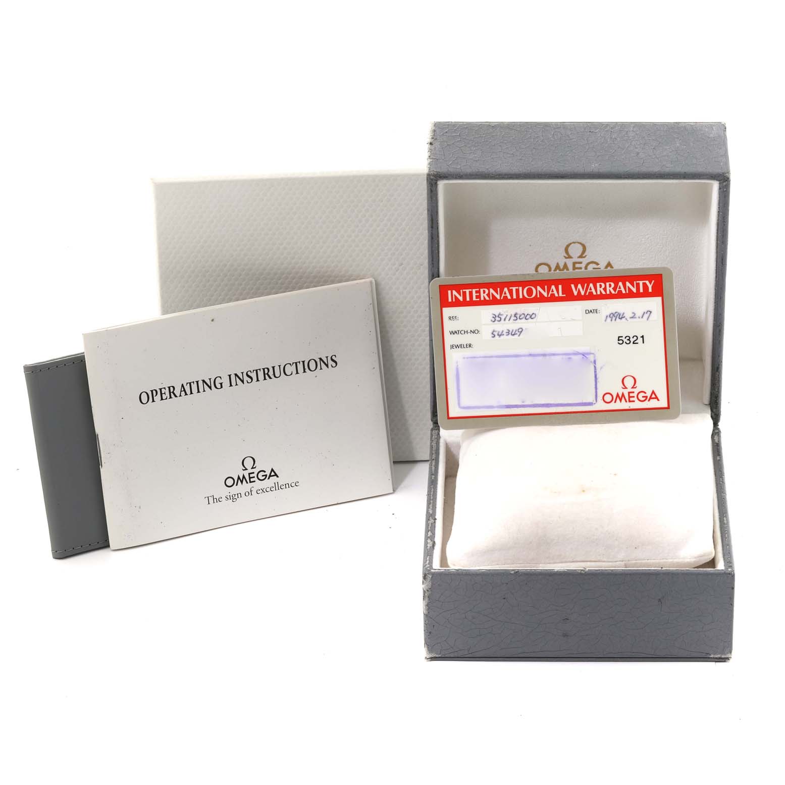 The image shows an Omega Seamaster 3511.50.00 Men
s Stainless Steel Black Dial 3511.50.00 Men
s Stainless Steel Black Dial watch box, an international warranty card, and an operating instructions booklet.