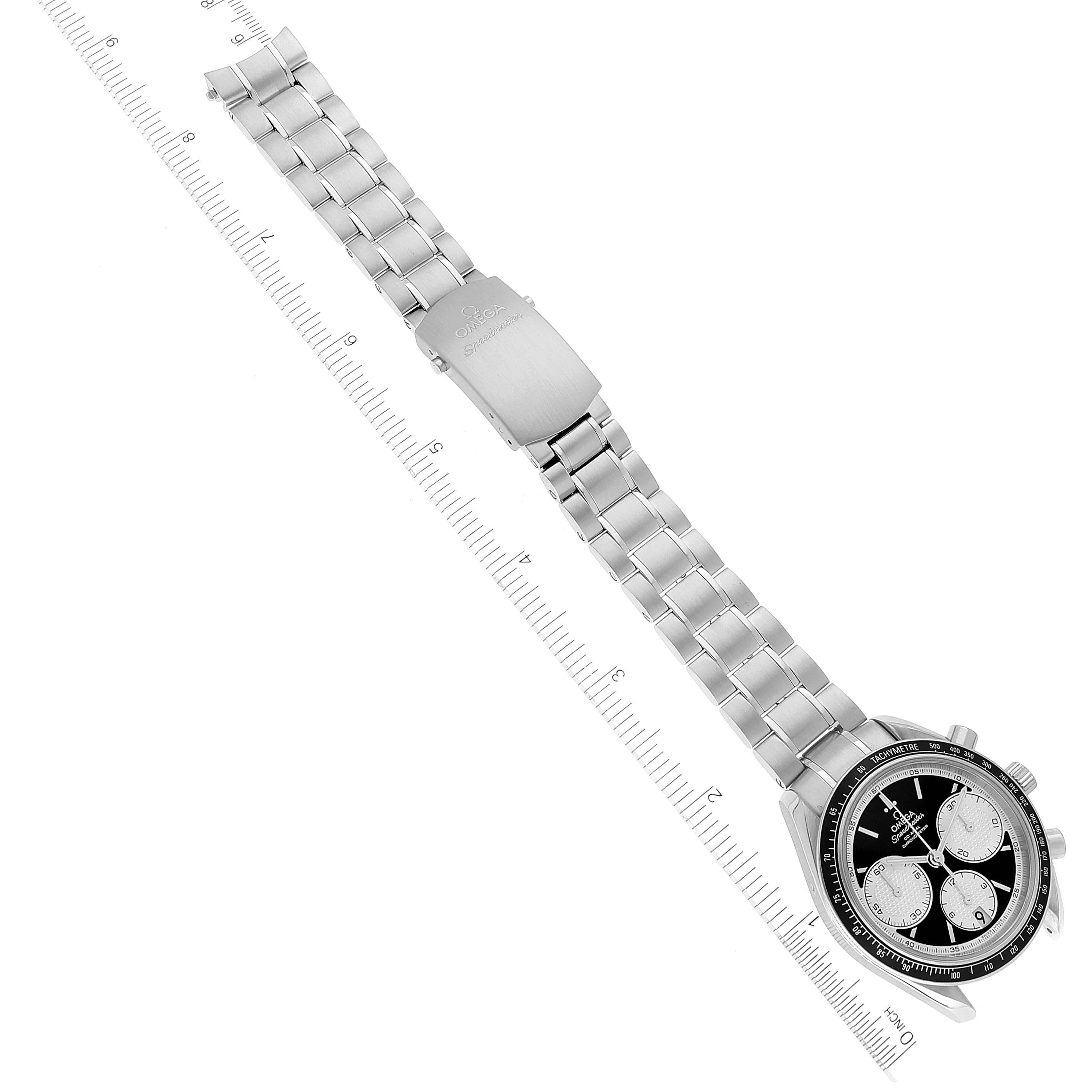 The image shows an Omega Speedmaster 326.30.40.50.01.002 Men
s Stainless Steel Black Dial 326.30.40.50.01.002 Men
s Stainless Steel Black Dial watch laid flat with its metal strap extended and a ruler beside it for scale.