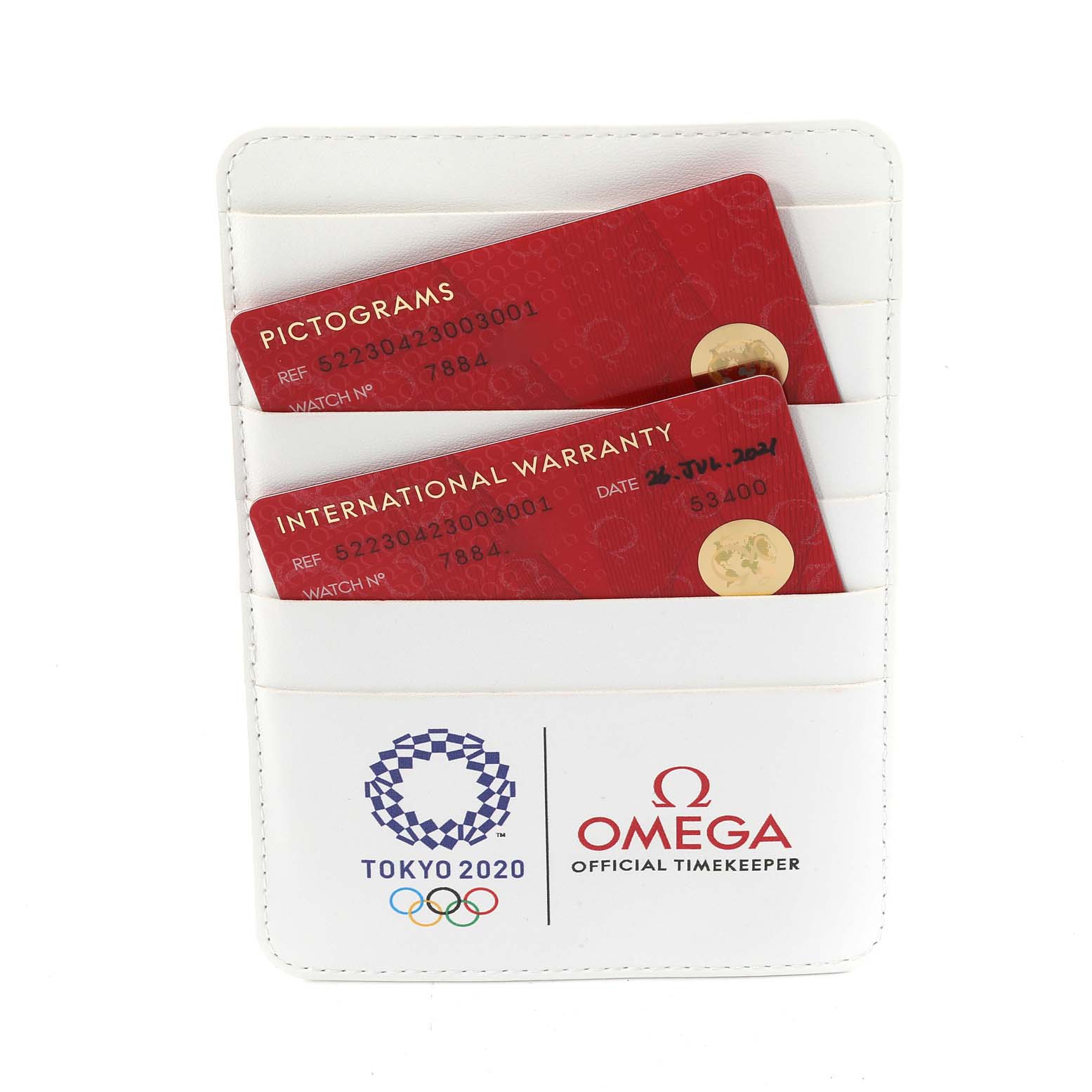 The image shows international warranty and pictograms cards in a white holder for an Omega Speedmaster 522.30.42.30.03.001 Men
s Stainless Steel Blue Dial 522.30.42.30.03.001 Men
s Stainless Steel Blue Dial watch.