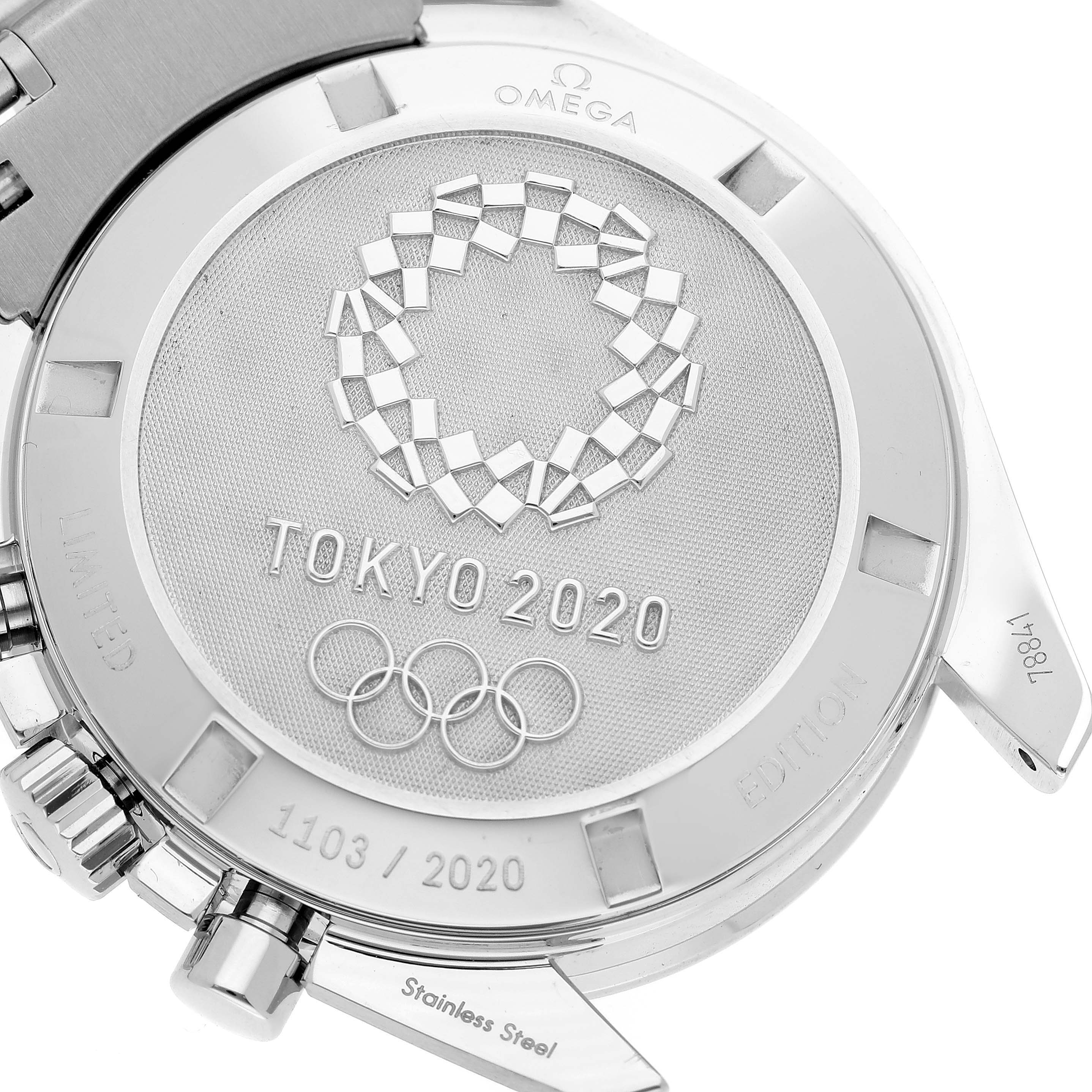 The image shows the back of an Omega Speedmaster 522.30.42.30.03.001 Men
s Stainless Steel Blue Dial 522.30.42.30.03.001 Men
s Stainless Steel Blue Dial watch engraved with "Tokyo 2020" and the Olympic rings.