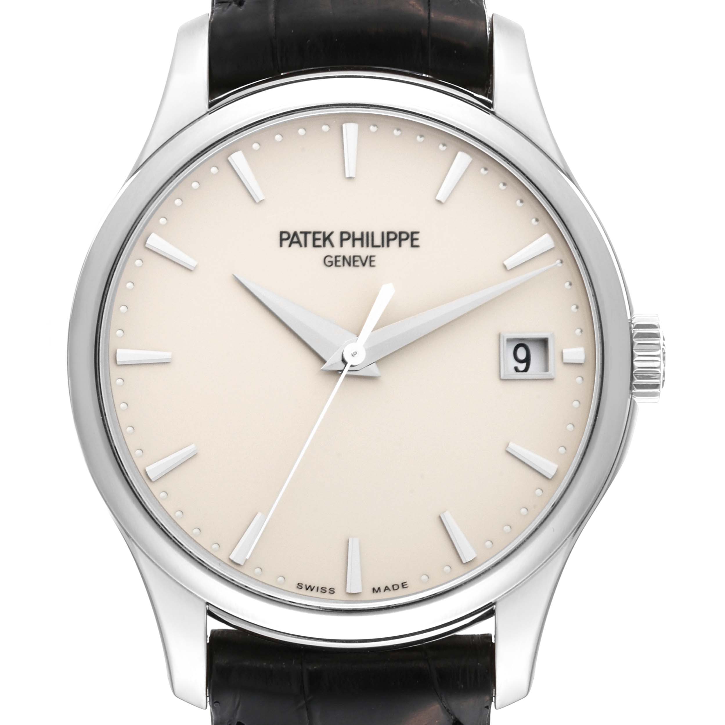 The image shows a front view of the Patek Philippe Calatrava 5227G-001 Men's White Gold Beige Dial 5227G-001 Men's White Gold Beige Dial watch, displaying its dial, hands, crown, and date window.