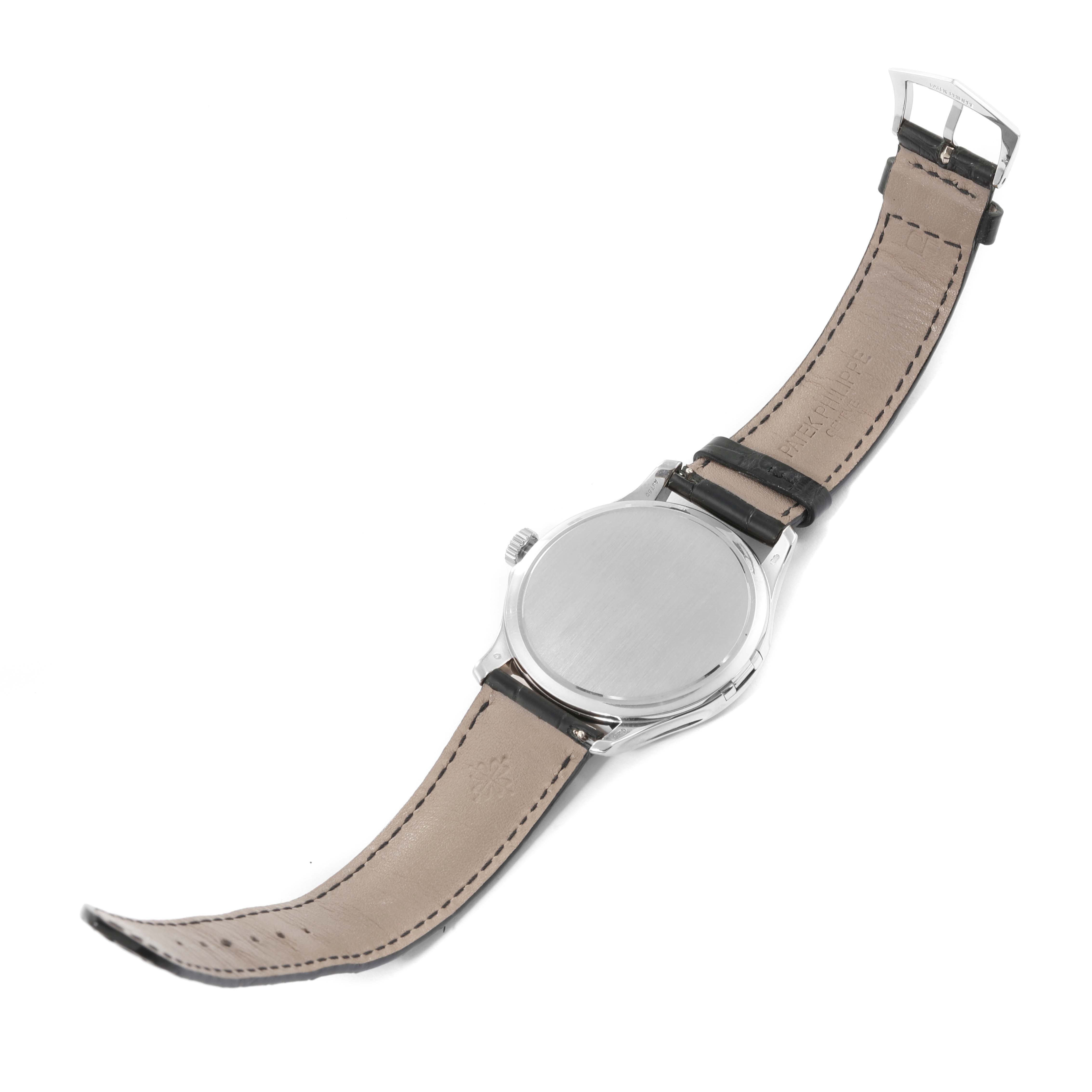 The image shows the back view of a Patek Philippe Calatrava 5227G-001 Men's White Gold Beige Dial 5227G-001 Men's White Gold Beige Dial watch with a leather strap and a closed clasp.