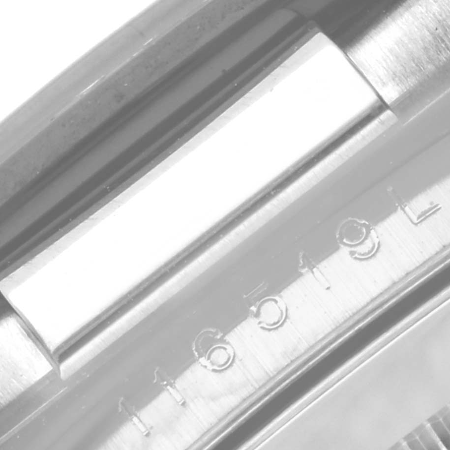 The image shows the case and serial number engraving of a Rolex Daytona 116519 Men's White Gold Grey Dial 116519 Men's White Gold Grey Dial watch viewed from the side.