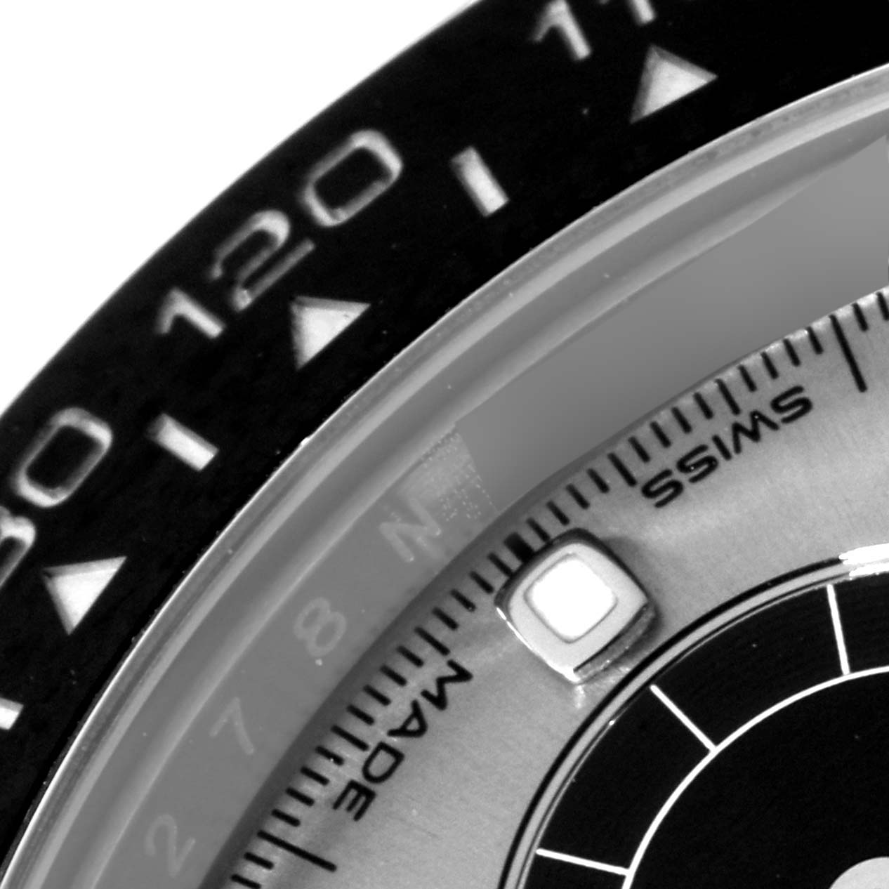 The image shows a close-up detail of the bezel and part of the dial of a Rolex Daytona 116519 Men's White Gold Grey Dial 116519 Men's White Gold Grey Dial watch.
