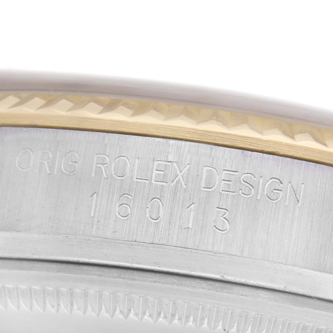 The image shows a close-up angle of the Rolex Vintage Collection 16013 Men
s Steel and Gold (two tone) Champagne Dial 16013 Men
s Steel and Gold (two tone) Champagne Dial 16013 model
s engraved side and part of the bezel.