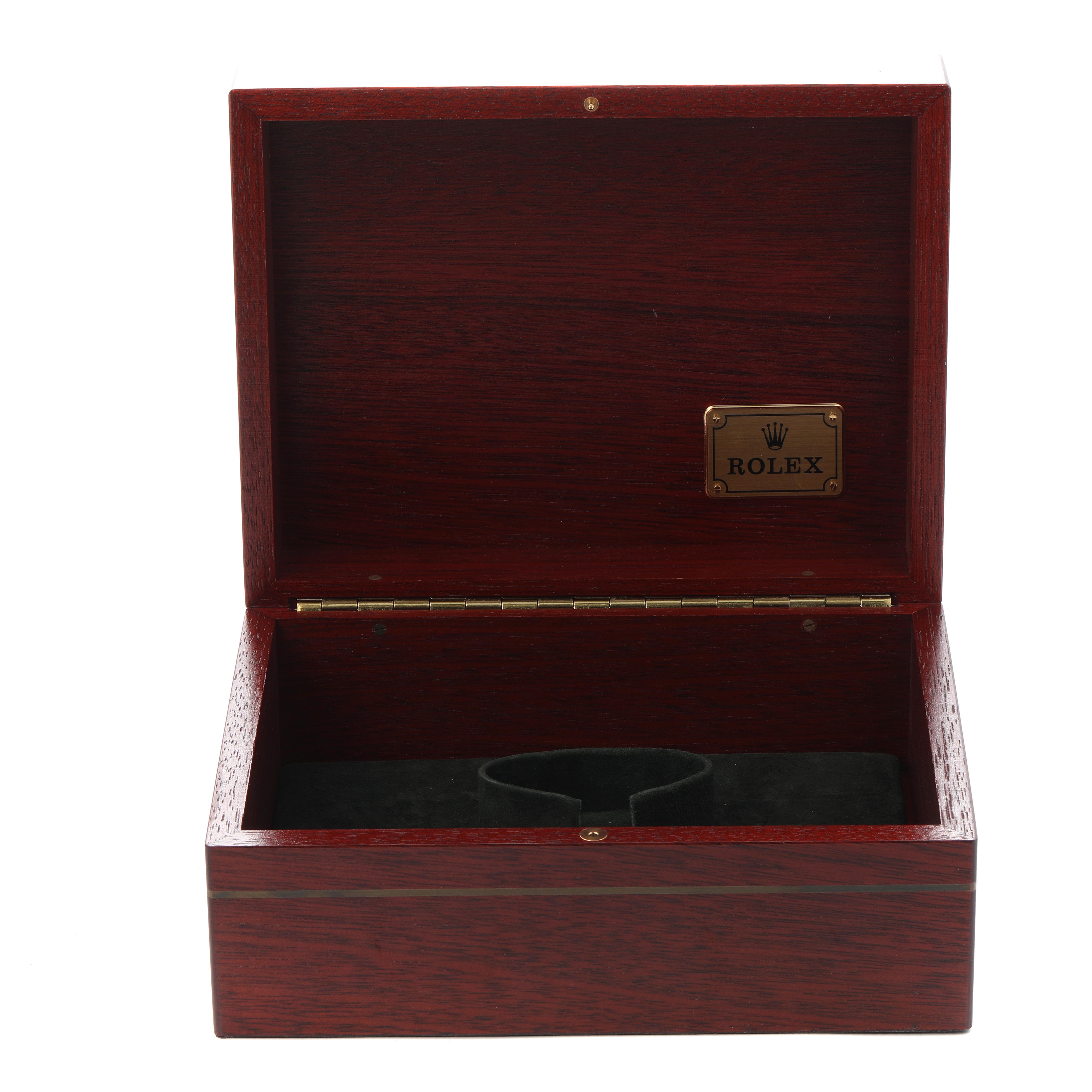The image shows an open Rolex Daytona 16518 Men
s Yellow Gold White Dial 16518 Men
s Yellow Gold White Dial watch box with a wooden finish and a Rolex logo inside.