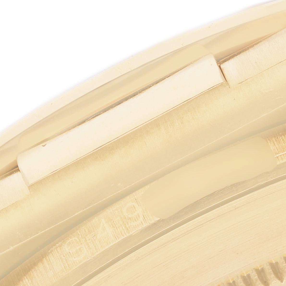 The image shows a close-up of the side edge of the Rolex Daytona 16518 Men
s Yellow Gold White Dial 16518 Men
s Yellow Gold White Dial watch case, highlighting the bezel and part of the case
s surface.