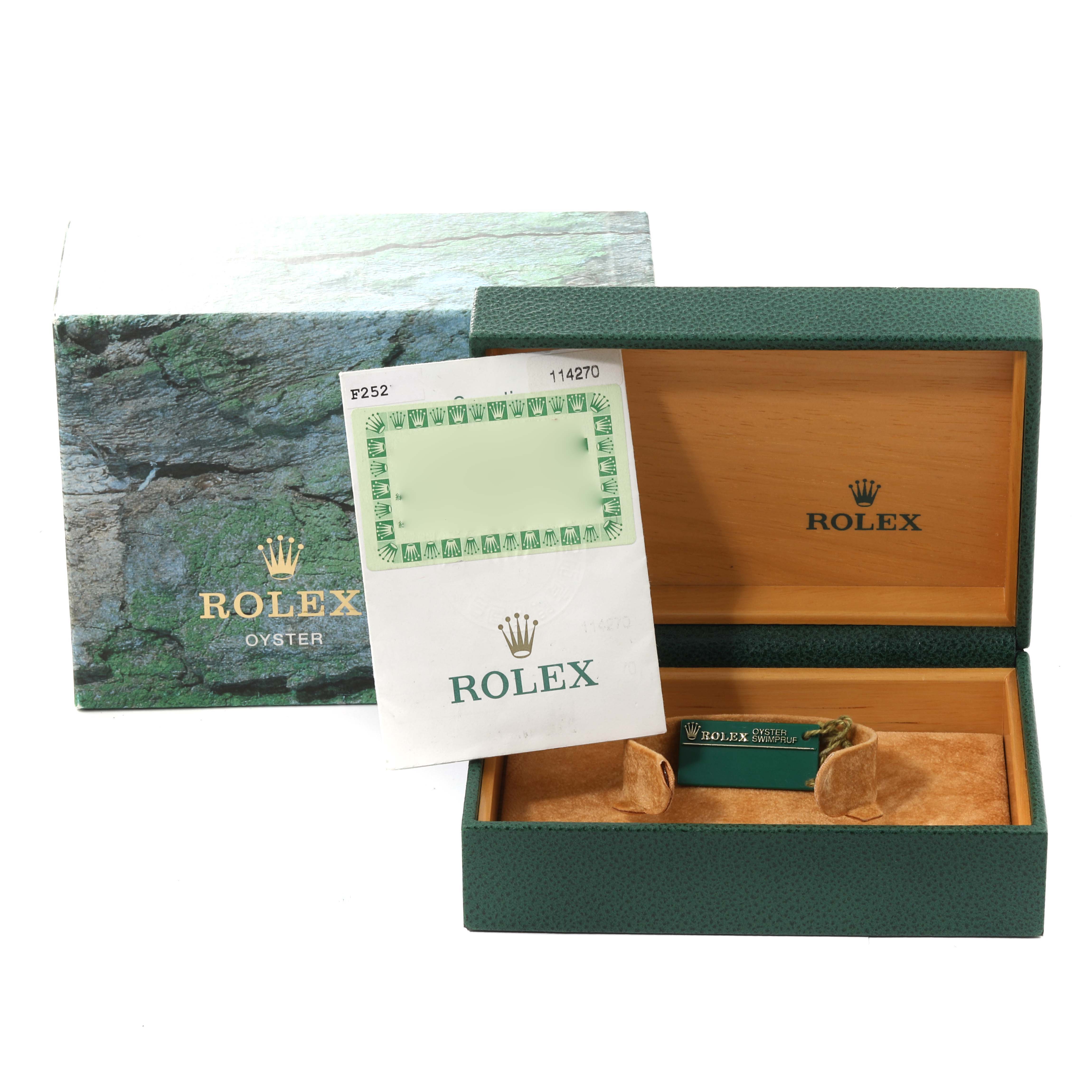 The image shows the box and papers for a Rolex Explorer 114270 Men's Stainless Steel Black Dial 114270 Men's Stainless Steel Black Dial model, including the outer box, inner box, and warranty card.