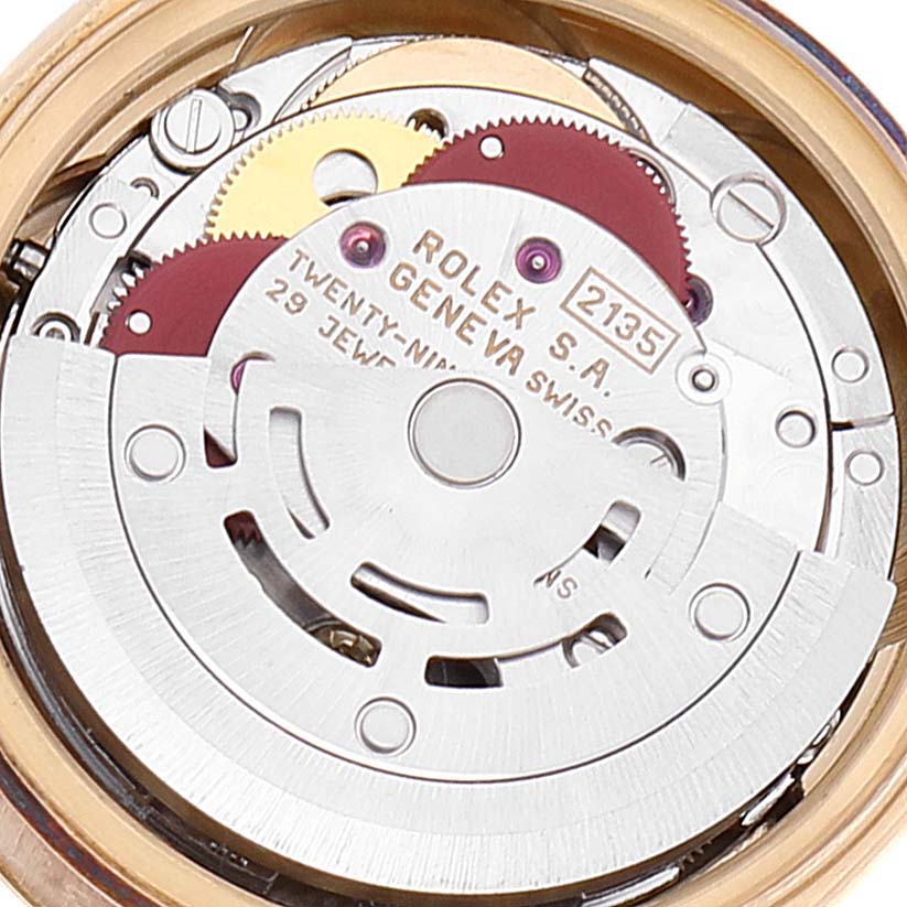This image shows the inner mechanism of a Rolex President 69178 Women
s Yellow Gold Champagne Dial 69178 Women
s Yellow Gold Champagne Dial model watch, highlighting the movement and gears from a close-up angle.