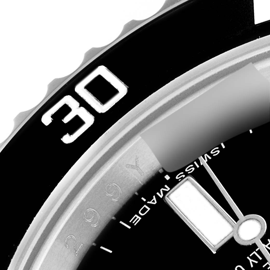This is a close-up of the bezel and part of the dial of a Rolex Submariner 114060 Men
s Stainless Steel Black Dial 114060 Men
s Stainless Steel Black Dial watch, showing the "30" minute mark.