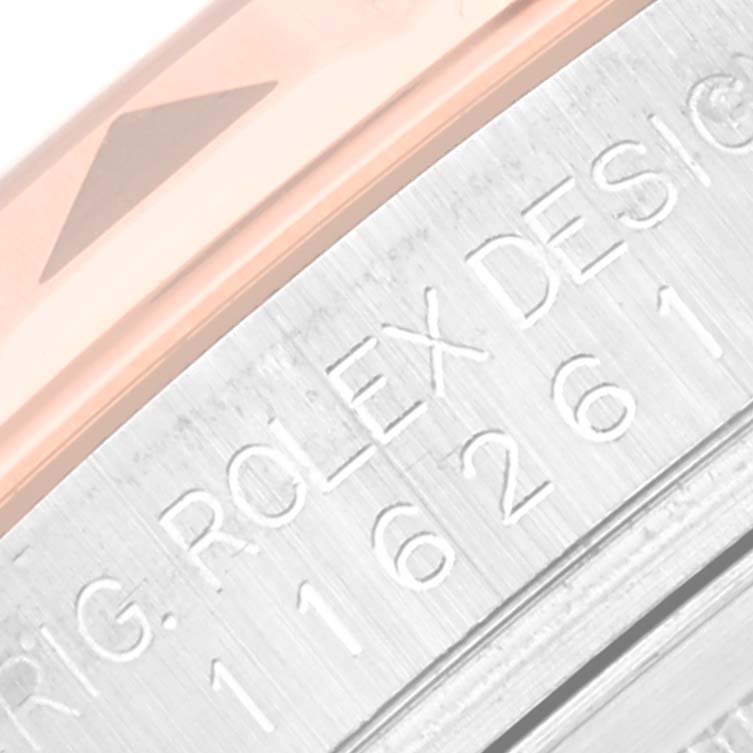 This close-up photo shows the engraving on the side of a Rolex Turn-o-Graph 116261 Men's Steel and Gold (two tone) Black Dial 116261 Men's Steel and Gold (two tone) Black Dial model, focusing on part of the bezel and case.