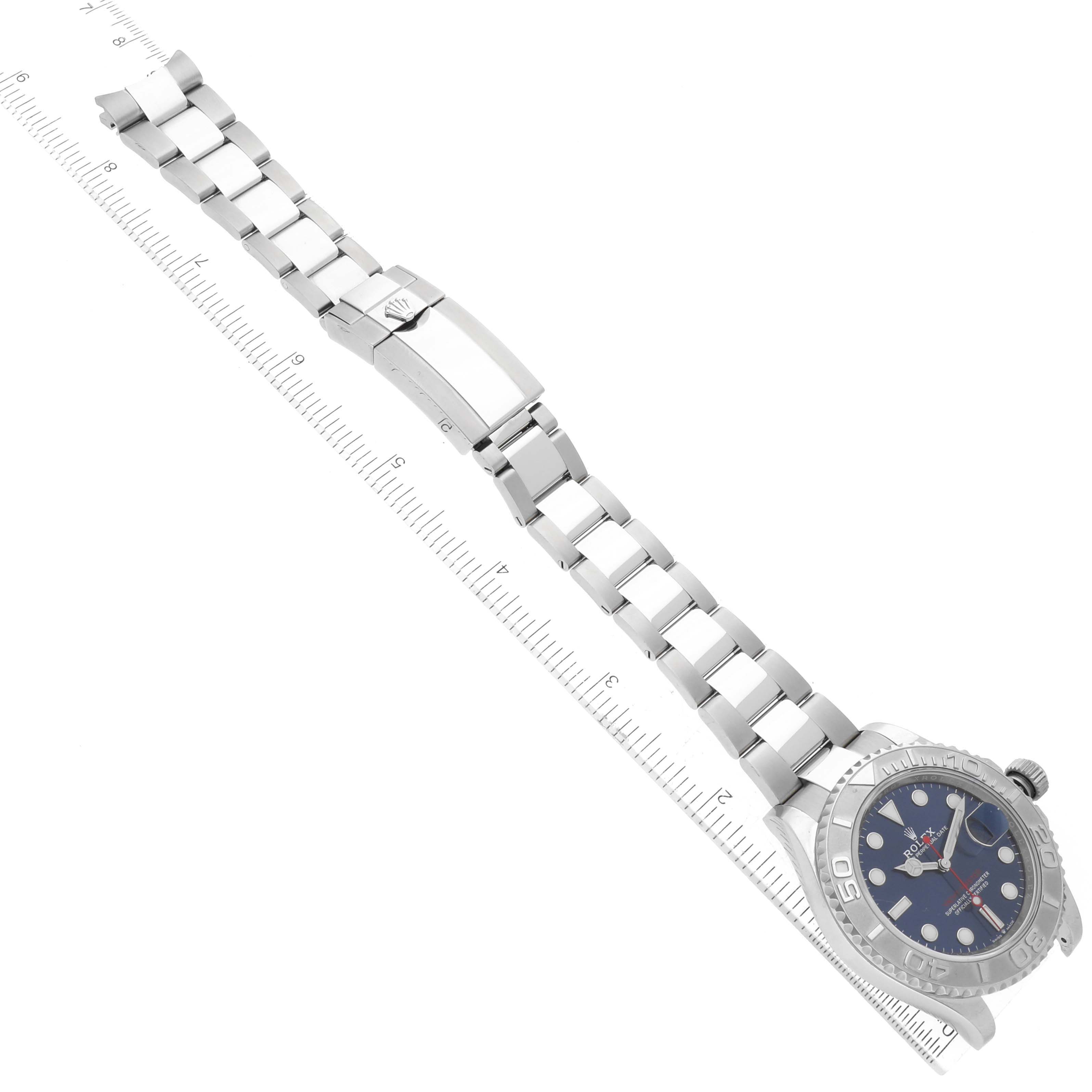 The image shows a Rolex Yacht-Master 126622 Men's Stainless Steel Blue Dial 126622 Men's Stainless Steel Blue Dial watch laid flat with its band extended and a measuring ruler beside it.