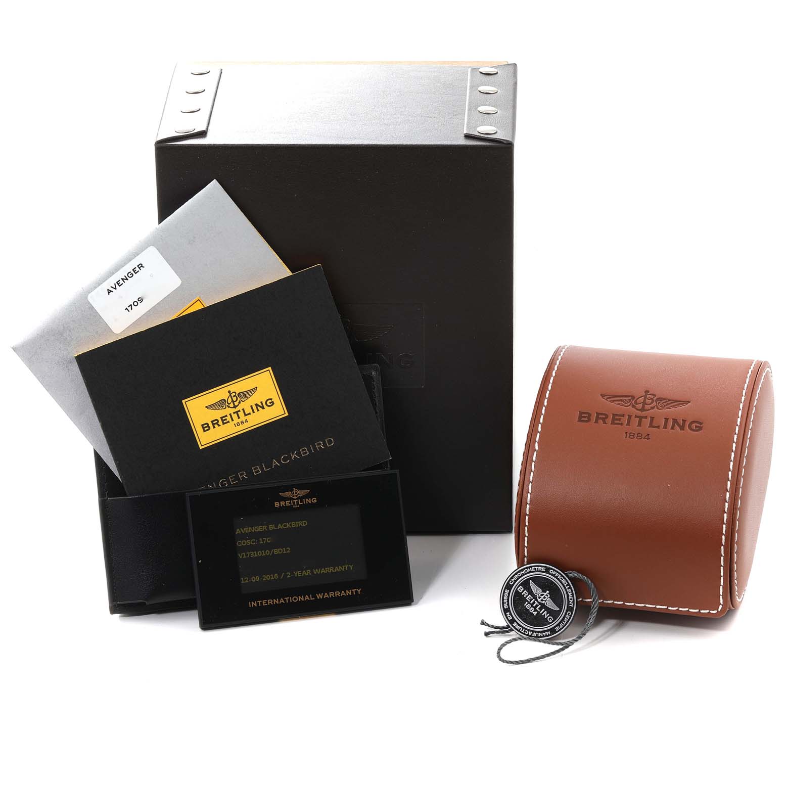 The image shows the Breitling Avenger V17310 Men's Titanium Black Dial V17310 Men's Titanium Black Dial watch accessories, including a box, warranty card, manuals, and a leather case, from a front angle.