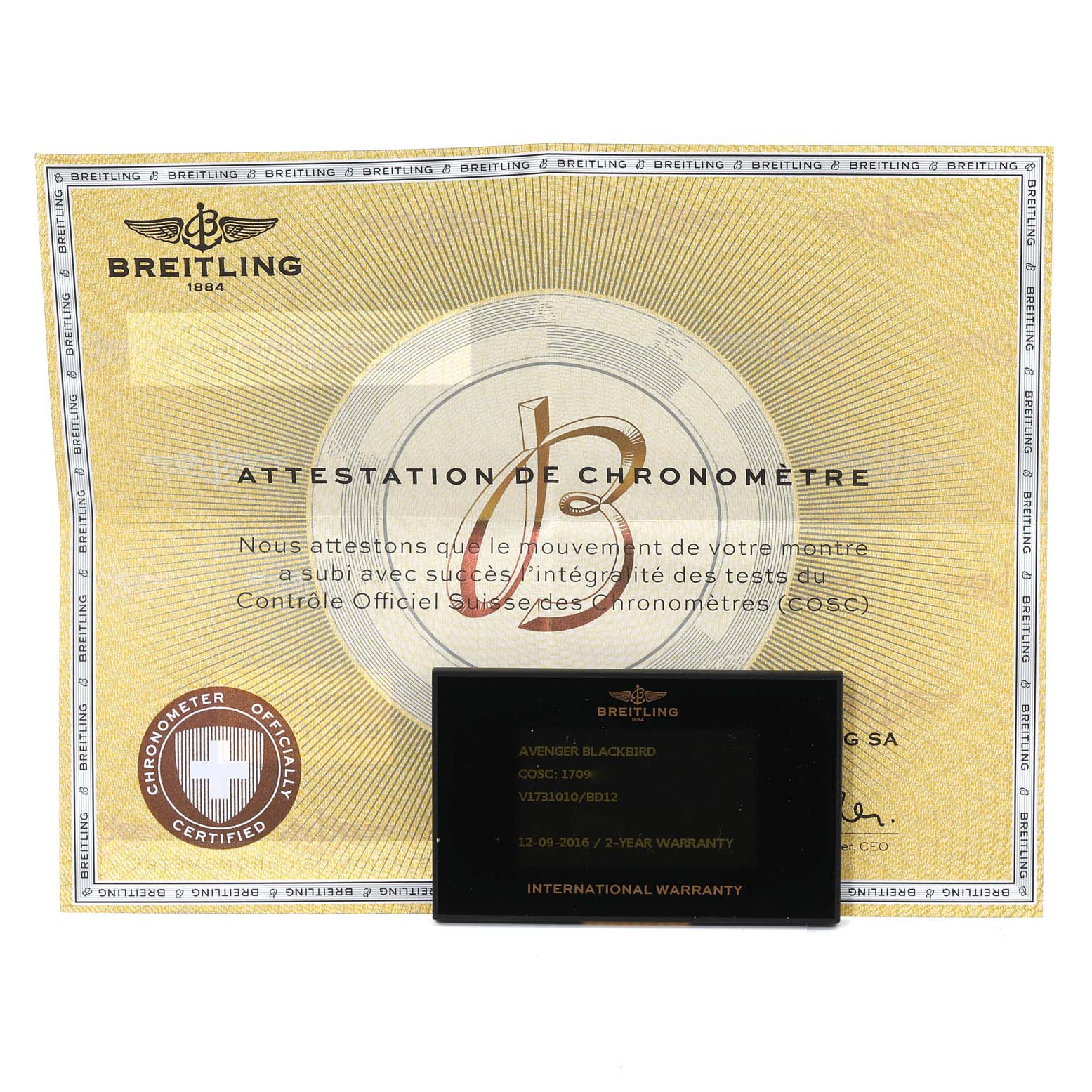 The image shows the warranty card and chronometer certificate for the Breitling Avenger V17310 Men's Titanium Black Dial V17310 Men's Titanium Black Dial model watch, from a top-down angle.