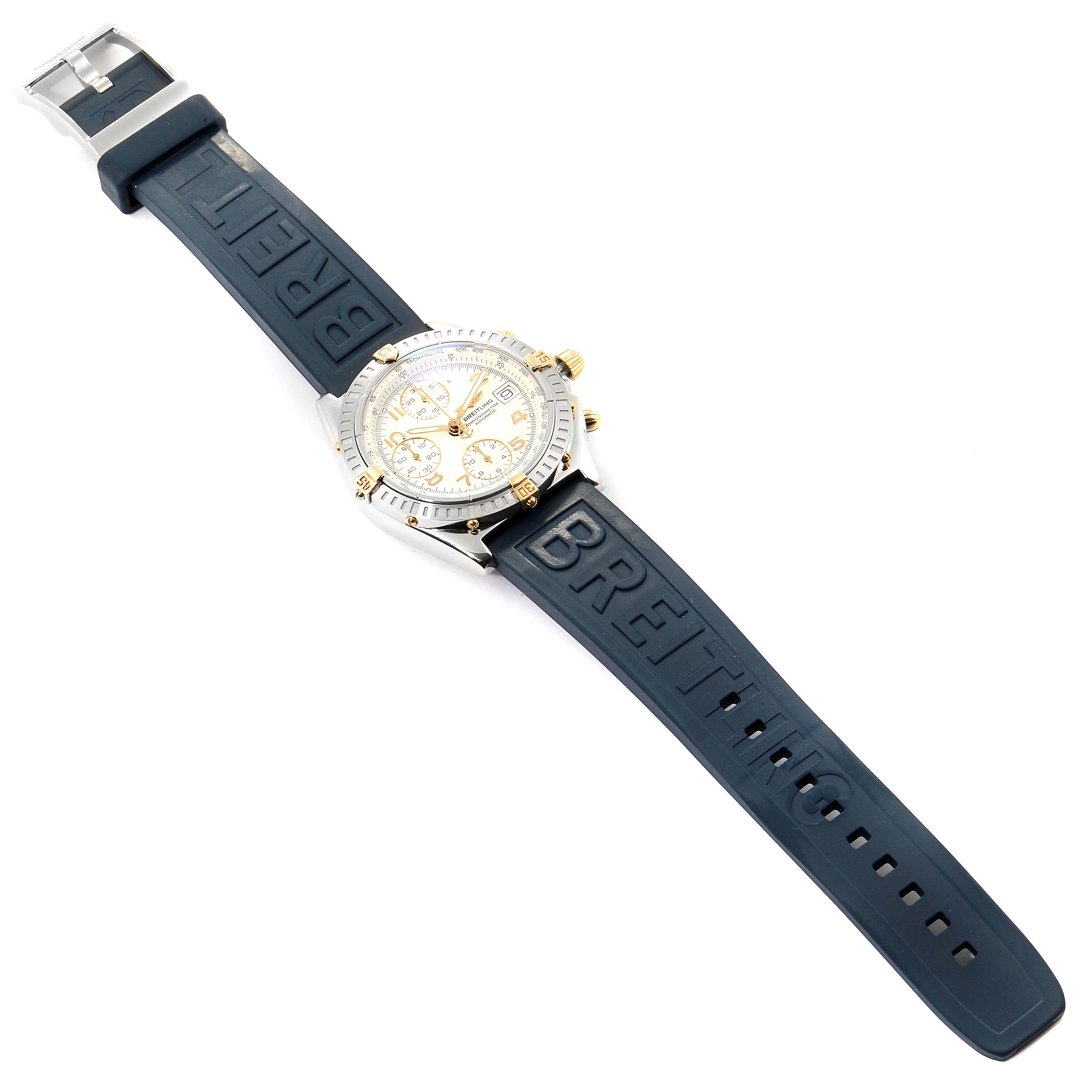 The image shows a Breitling Chronomat B13352 Men's Steel and Gold (two tone) White Dial B13352 Men's Steel and Gold (two tone) White Dial watch lying flat, displaying the full face and rubber strap with branding.