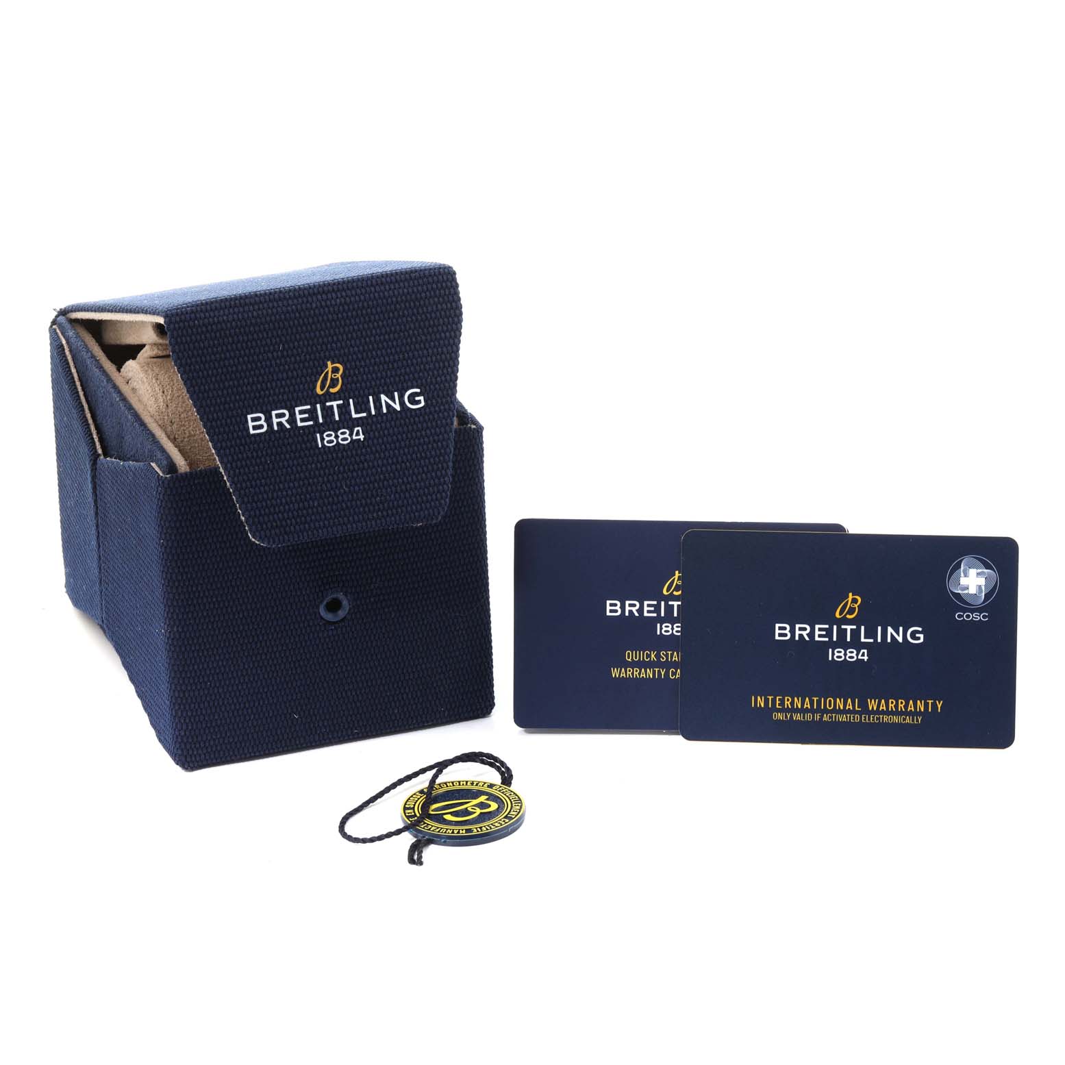 The image shows Breitling packaging and accessories for the Superocean model, including a box, warranty cards, and a tag.