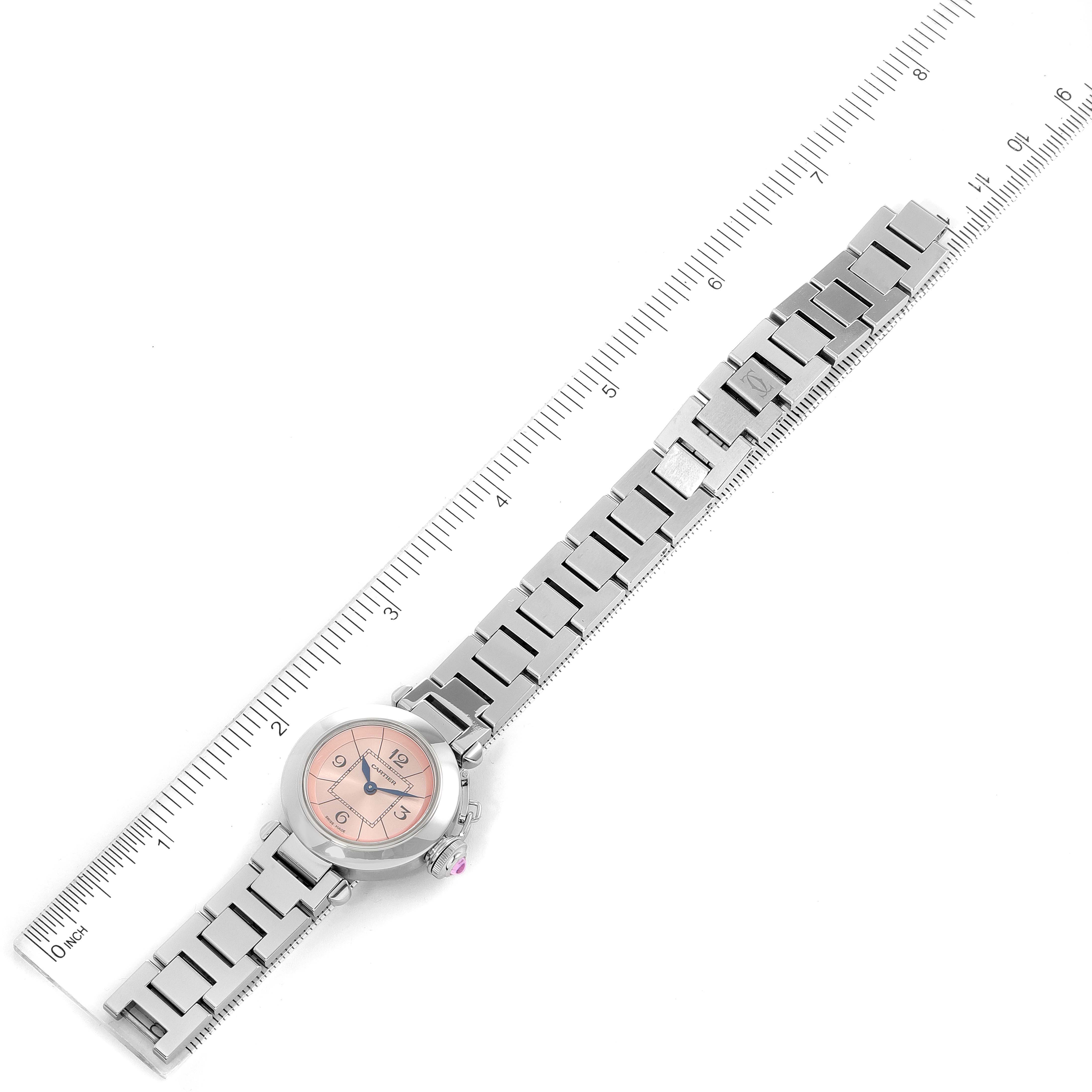 The image shows a Cartier Pasha W3140008 Women's Stainless Steel Pink Dial W3140008 Women's Stainless Steel Pink Dial watch laid flat, featuring its face, bracelet band, and a ruler to measure its length.
