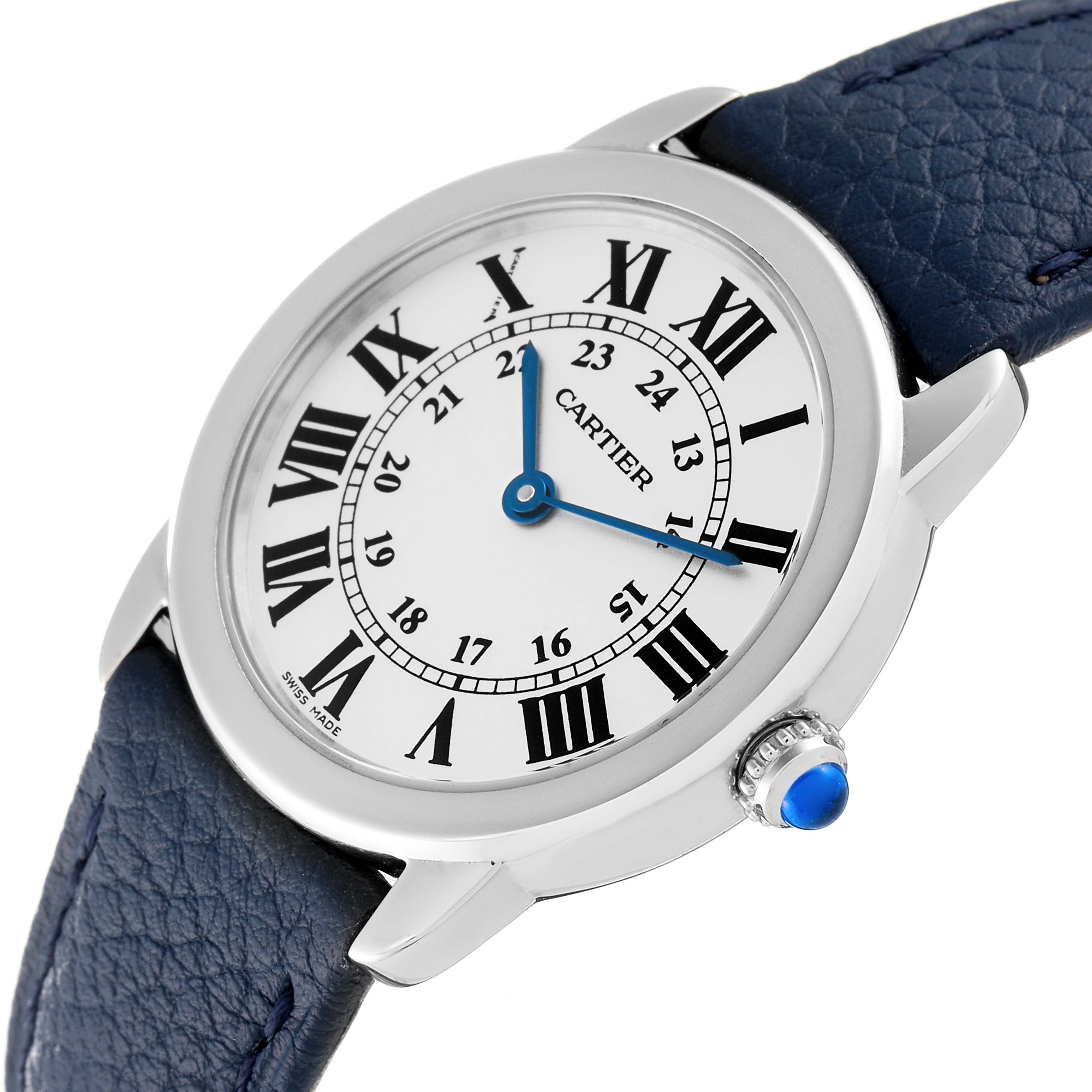 This Ronde model by Cartier is shown at a tilted angle, displaying its white dial, Roman numerals, blue hands, and crown with a blue cabochon.