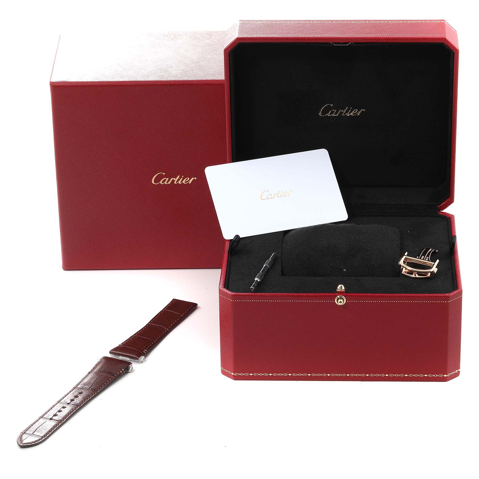 The image shows a Cartier Santos WGSA029 Men
s Yellow Gold Silver Dial WGSA029 Men
s Yellow Gold Silver Dial watch box with an additional leather strap, a card, and watch tools.
