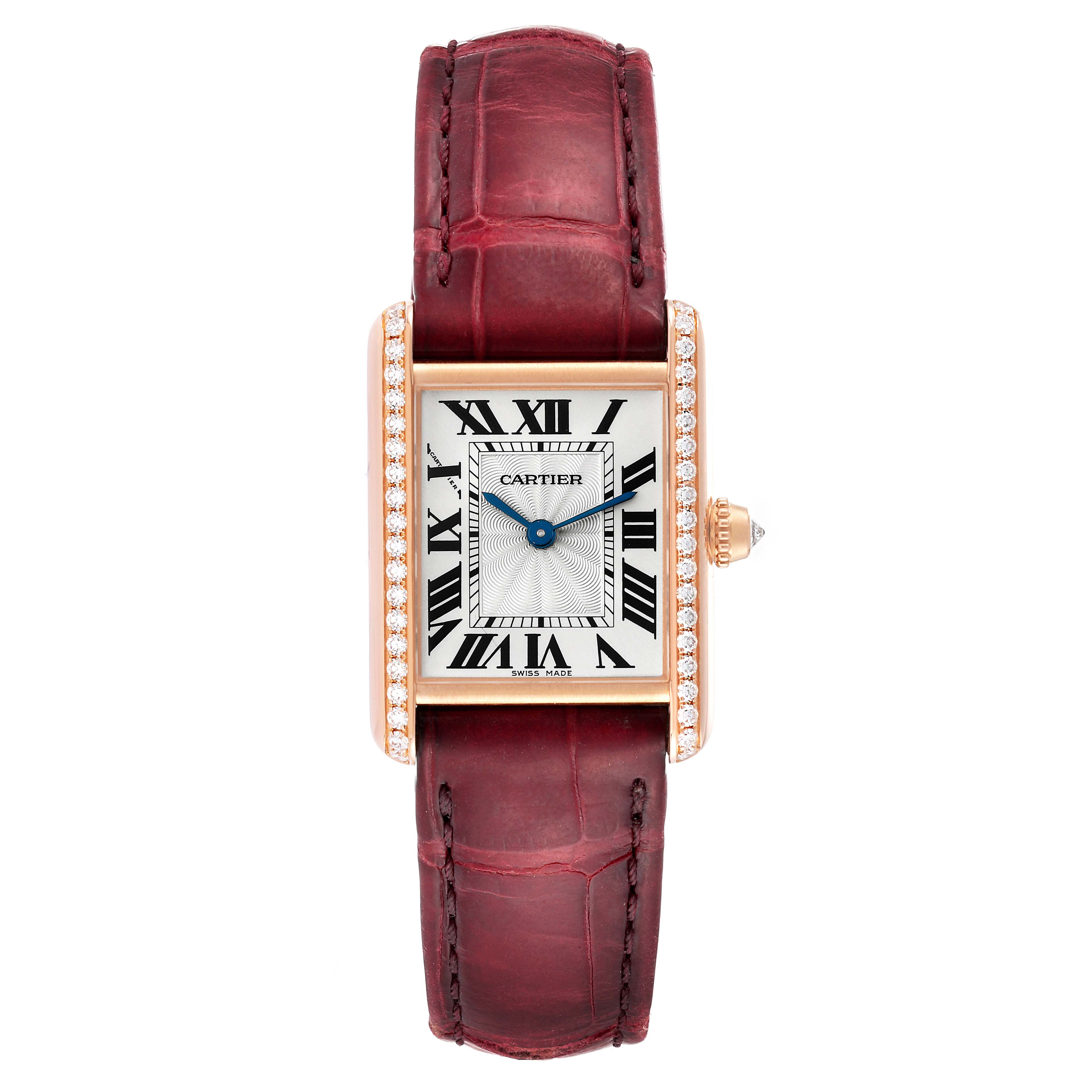 This image shows a Tank Louis watch by Cartier, photographed from the front, highlighting its rectangular dial with Roman numerals, diamond-set bezel, blue hands, and brown leather strap.