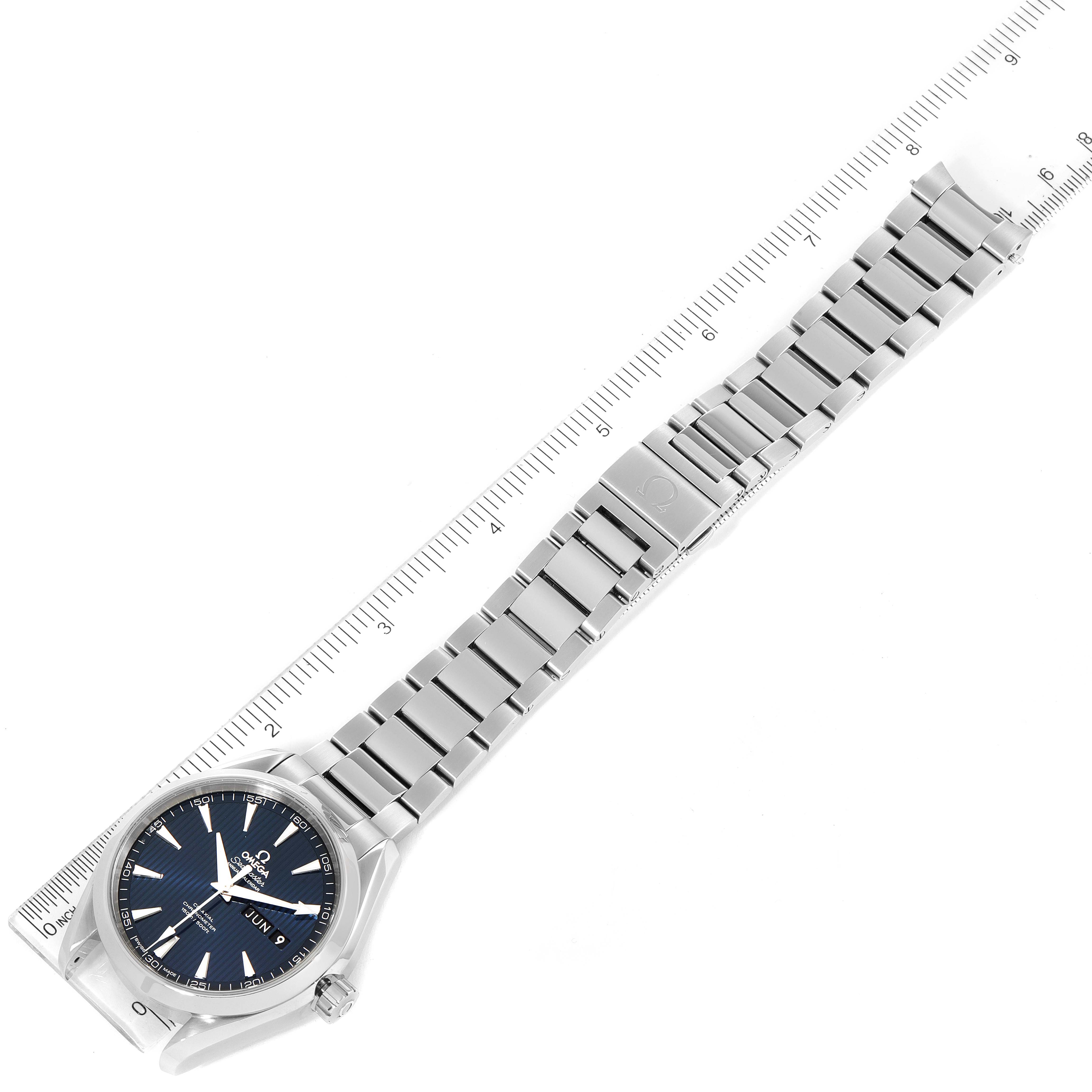 The image shows a top-down view of an Omega Aqua Terra 231.10.43.22.03.002 Men's Stainless Steel Blue Dial 231.10.43.22.03.002 Men's Stainless Steel Blue Dial watch, displaying its face, metal bracelet, and secured clasp next to a ruler.