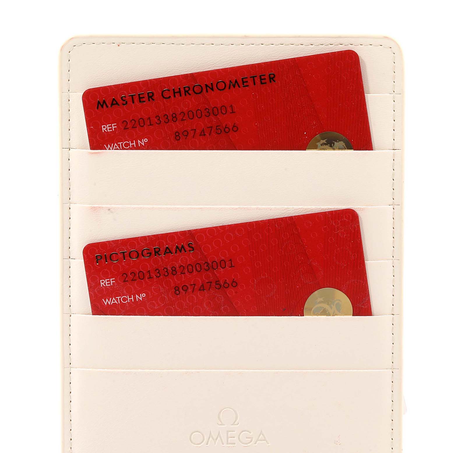 The image shows two red certification cards in a holder for the Omega Aqua Terra 220.13.38.20.03.001 Men's Stainless Steel Blue Dial 220.13.38.20.03.001 Men's Stainless Steel Blue Dial model watch.