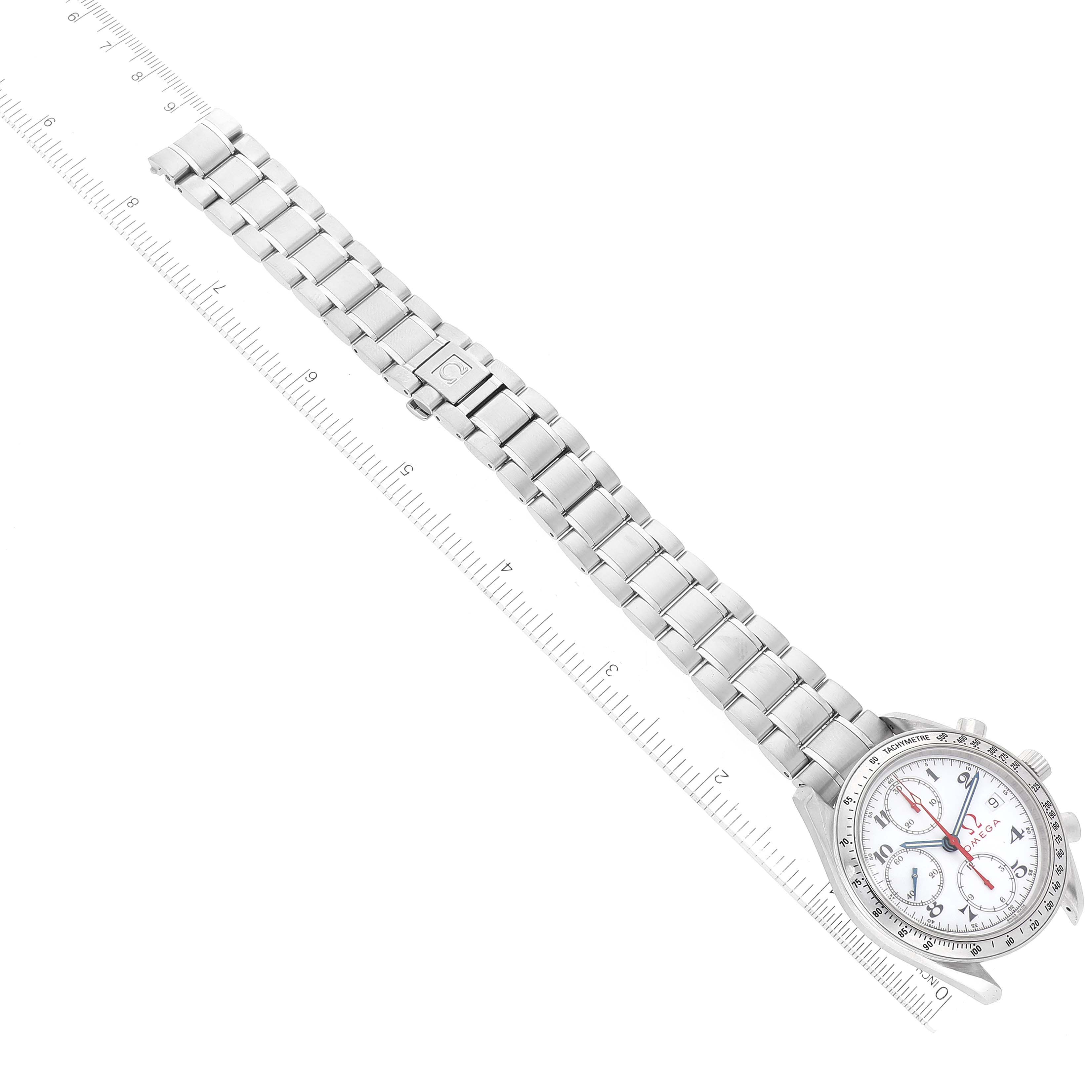 The image shows an Omega Speedmaster 3513.20.00 Men's Stainless Steel White Dial 3513.20.00 Men's Stainless Steel White Dial watch laid flat, displaying the bracelet, face, and clasp, with a ruler for scale.
