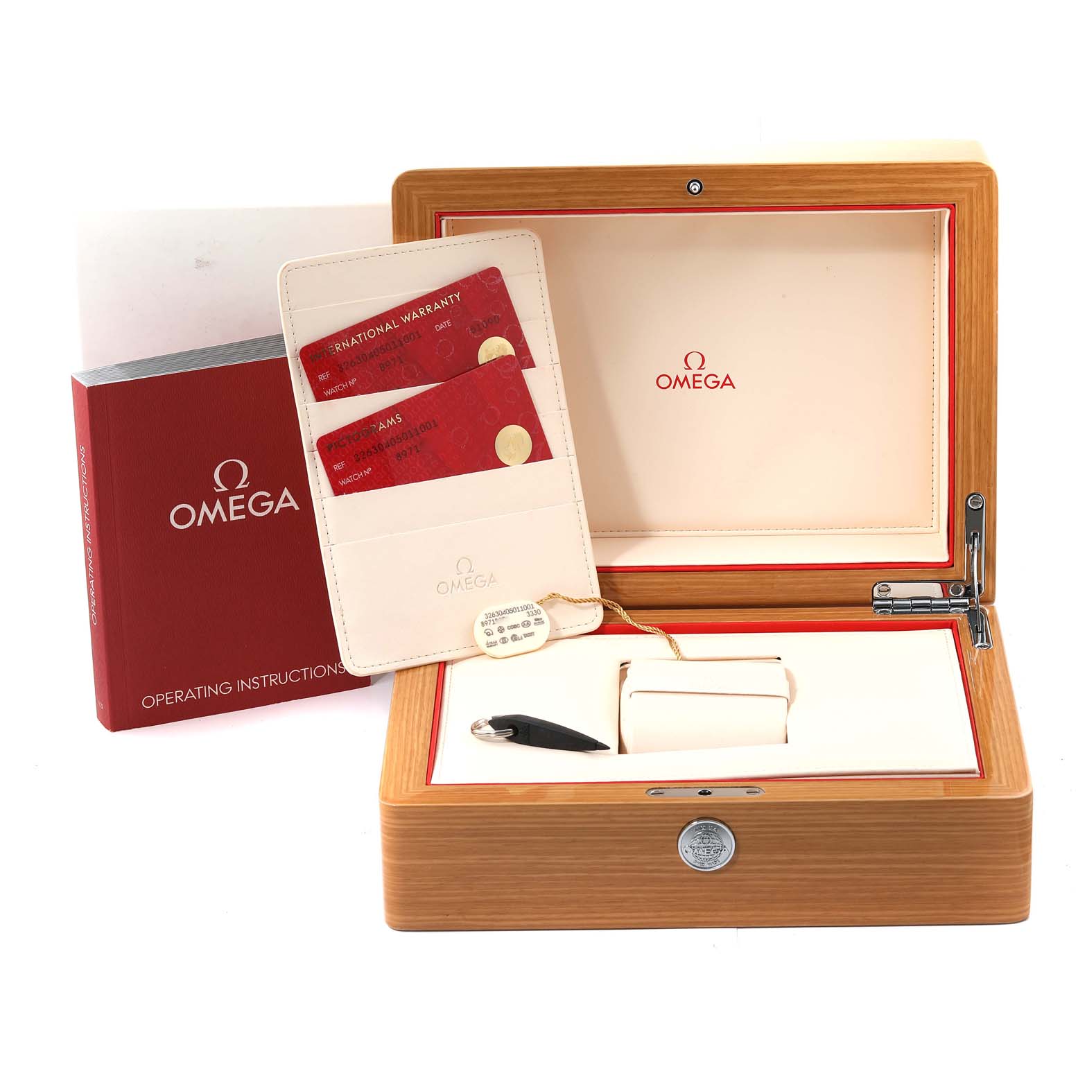 The image shows an Omega Speedmaster 326.30.40.50.11.001 Men
s Stainless Steel Red Dial 326.30.40.50.11.001 Men
s Stainless Steel Red Dial watch box set, including the open wooden box, international warranty cards, operating instructions, and a watch cushion.