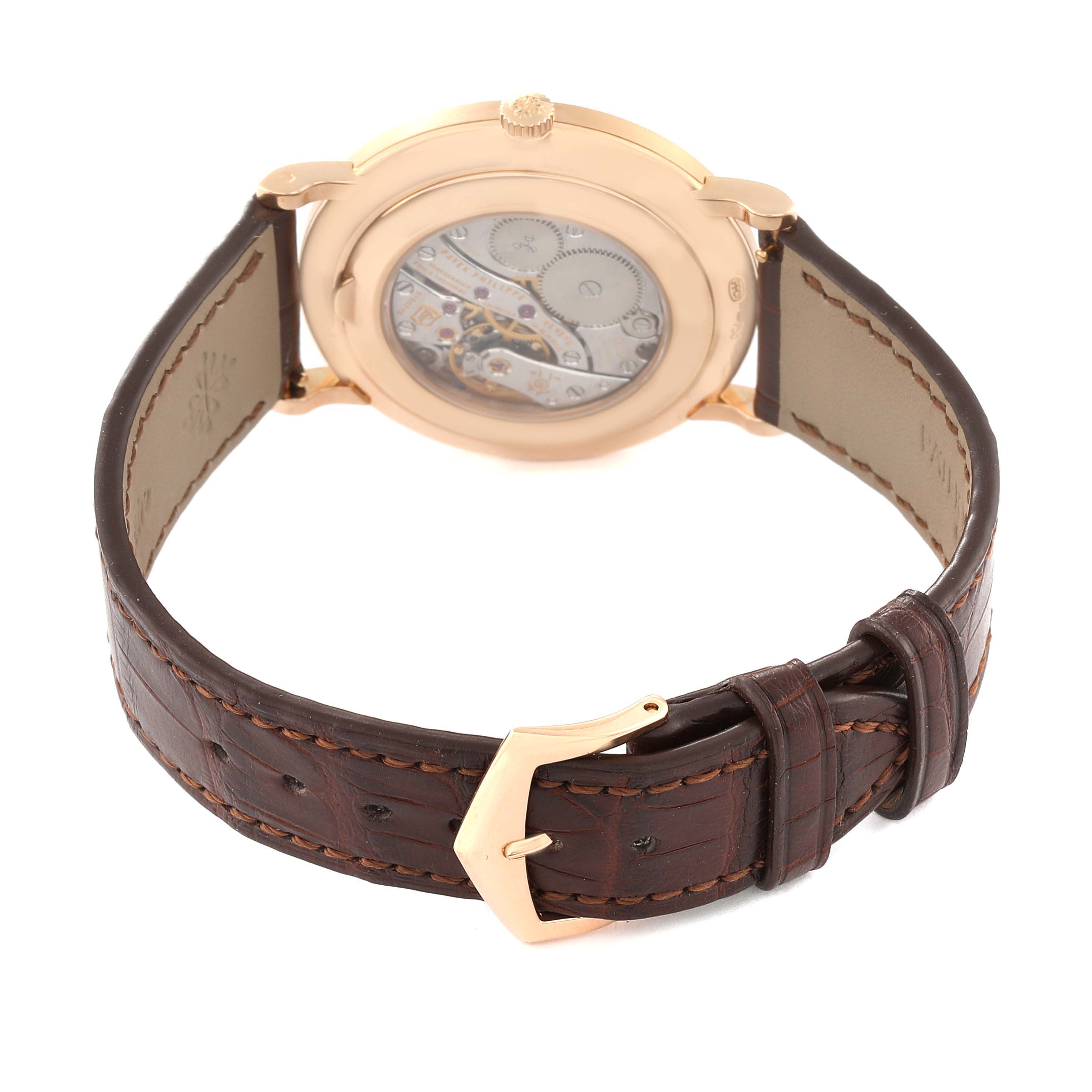This image shows the back of a Patek Philippe Calatrava 5116R Men's Rose Gold White Dial 5116R Men's Rose Gold White Dial watch, highlighting its movement and brown leather strap.