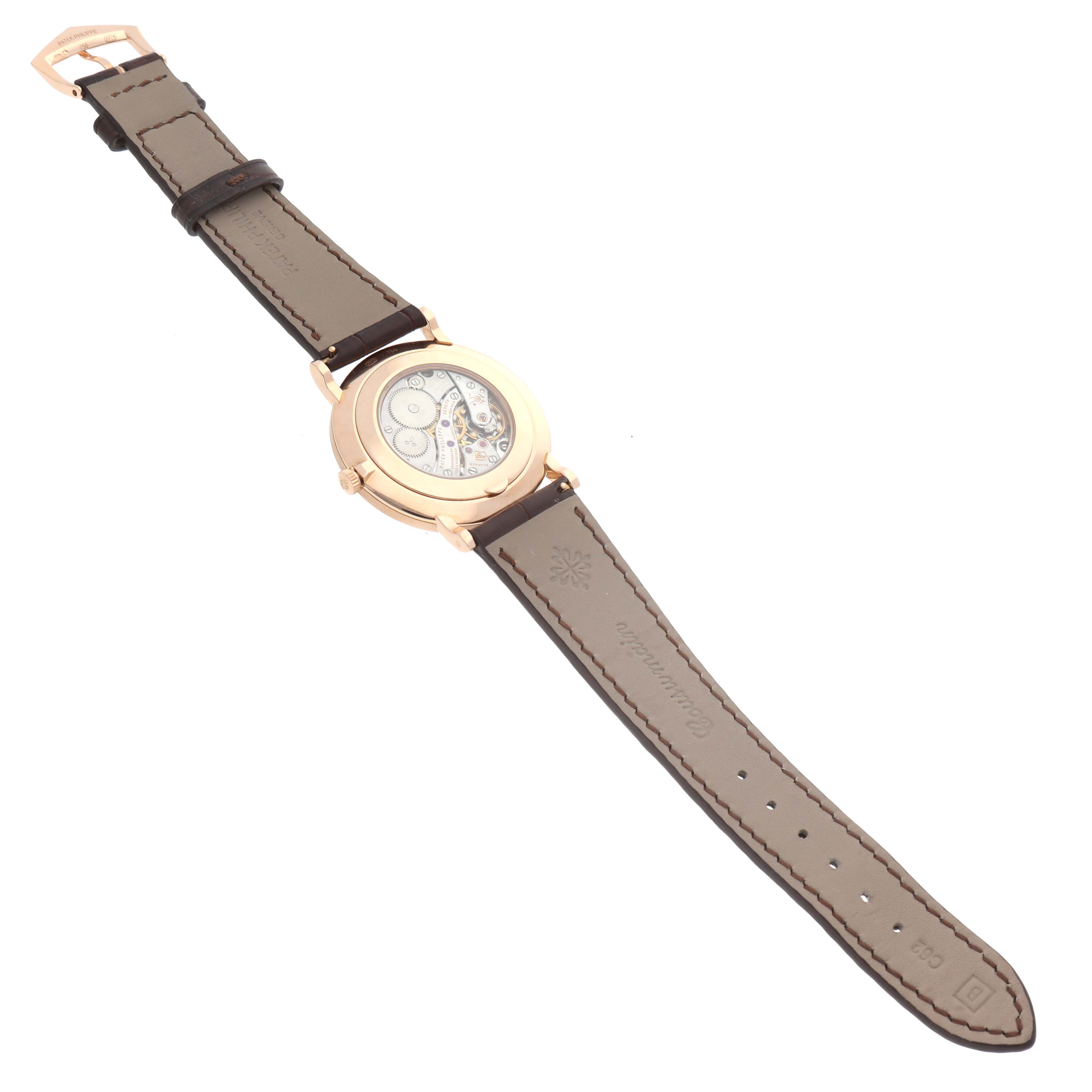 The image shows a Patek Philippe Calatrava 5116R Men's Rose Gold White Dial 5116R Men's Rose Gold White Dial watch from a top-down angle, focusing on the back case and strap.