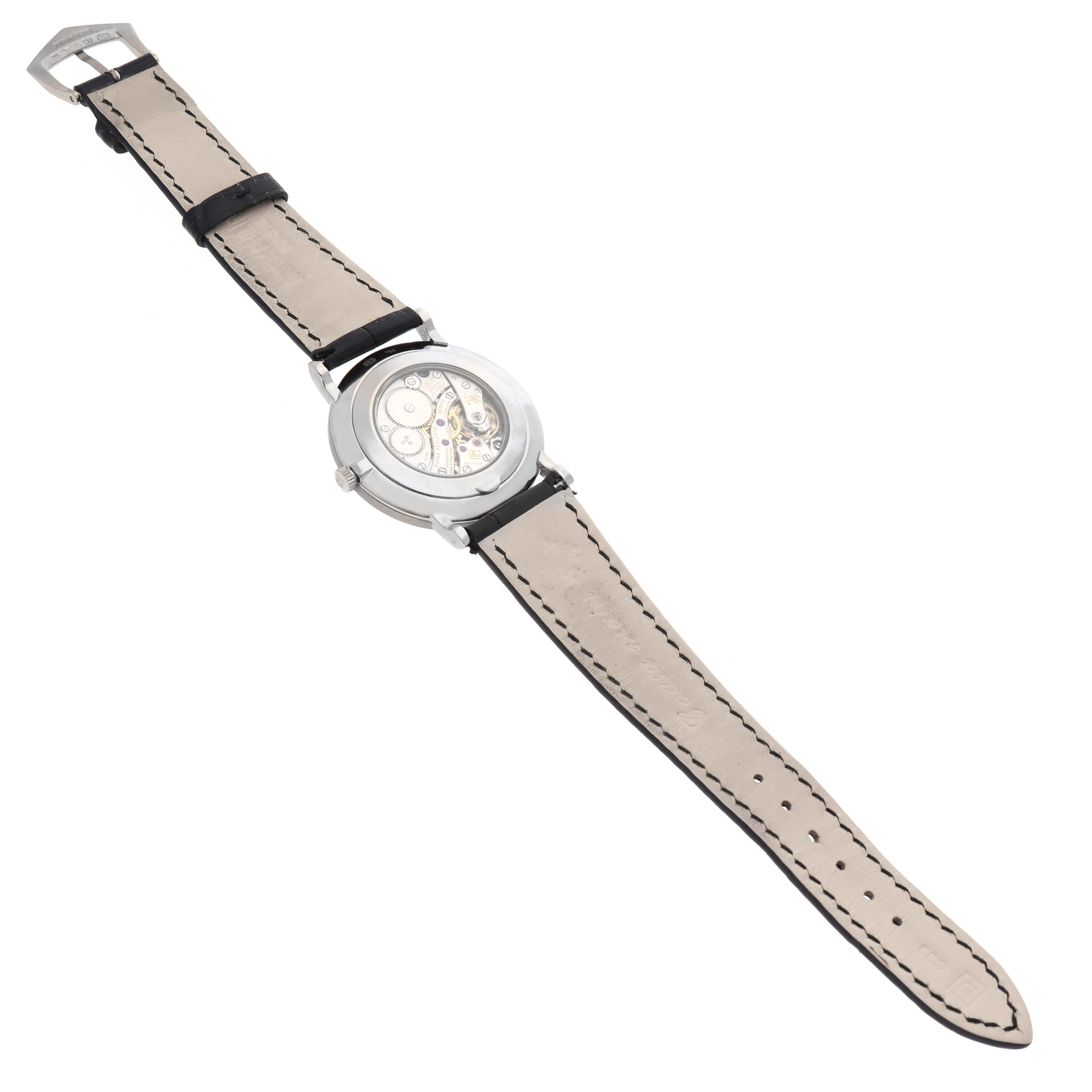 This image shows the back view of the Patek Philippe Calatrava 5116G Men
s White Gold White Dial 5116G Men
s White Gold White Dial model, displaying its inner mechanisms and leather strap.