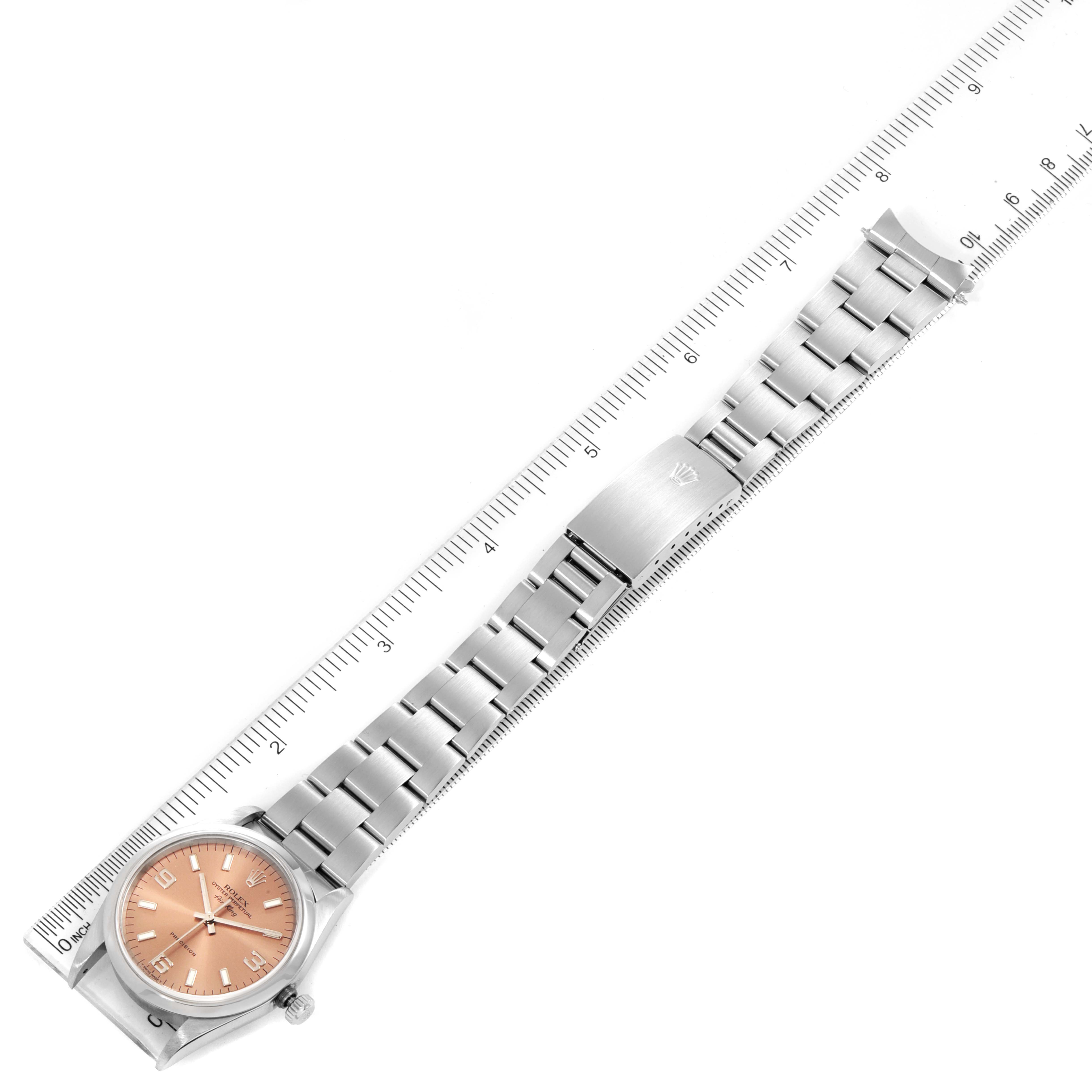 The image shows a top view of a Rolex Air-King 14000 Men's Stainless Steel Pink Dial 14000 Men's Stainless Steel Pink Dial watch with its entire bracelet against a ruler for scale.