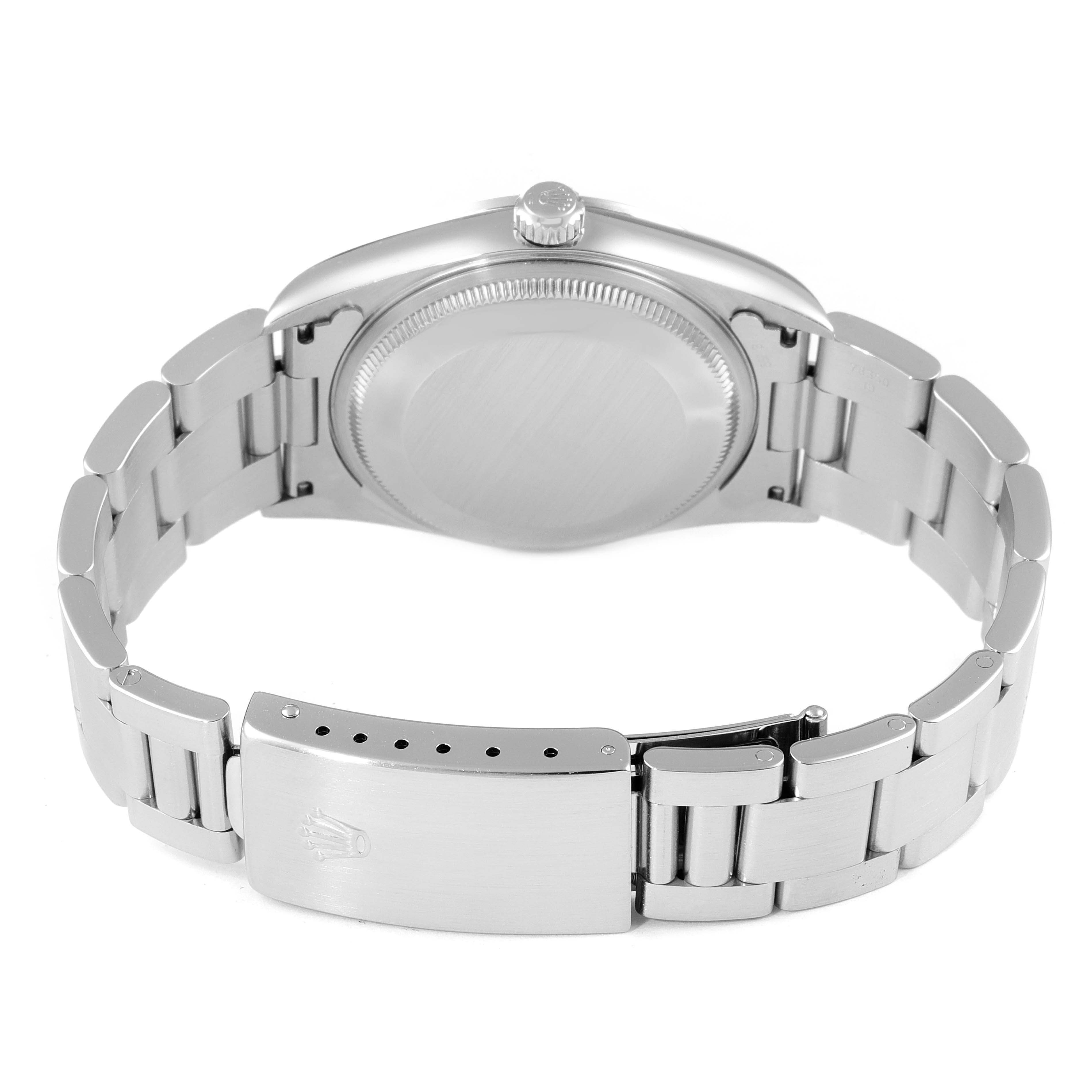 The image shows the back of a Rolex Air-King 14000 Men's Stainless Steel Pink Dial 14000 Men's Stainless Steel Pink Dial watch, including its closed caseback and bracelet with a clasp.