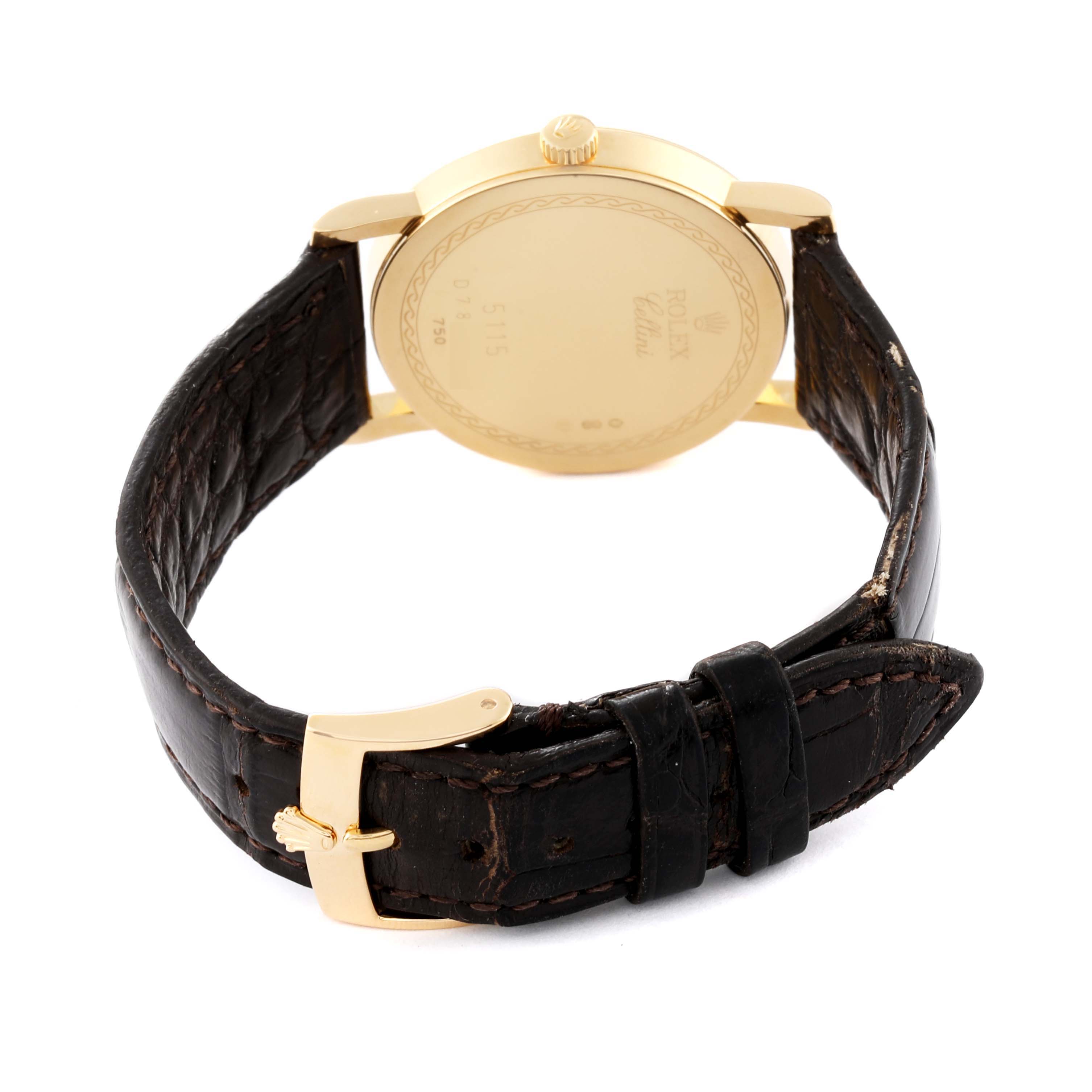 This angle shows the back of the Rolex Cellini 5115 Men's Yellow Gold Silver Dial 5115 Men's Yellow Gold Silver Dial watch, highlighting its gold back case and leather strap with a gold buckle.