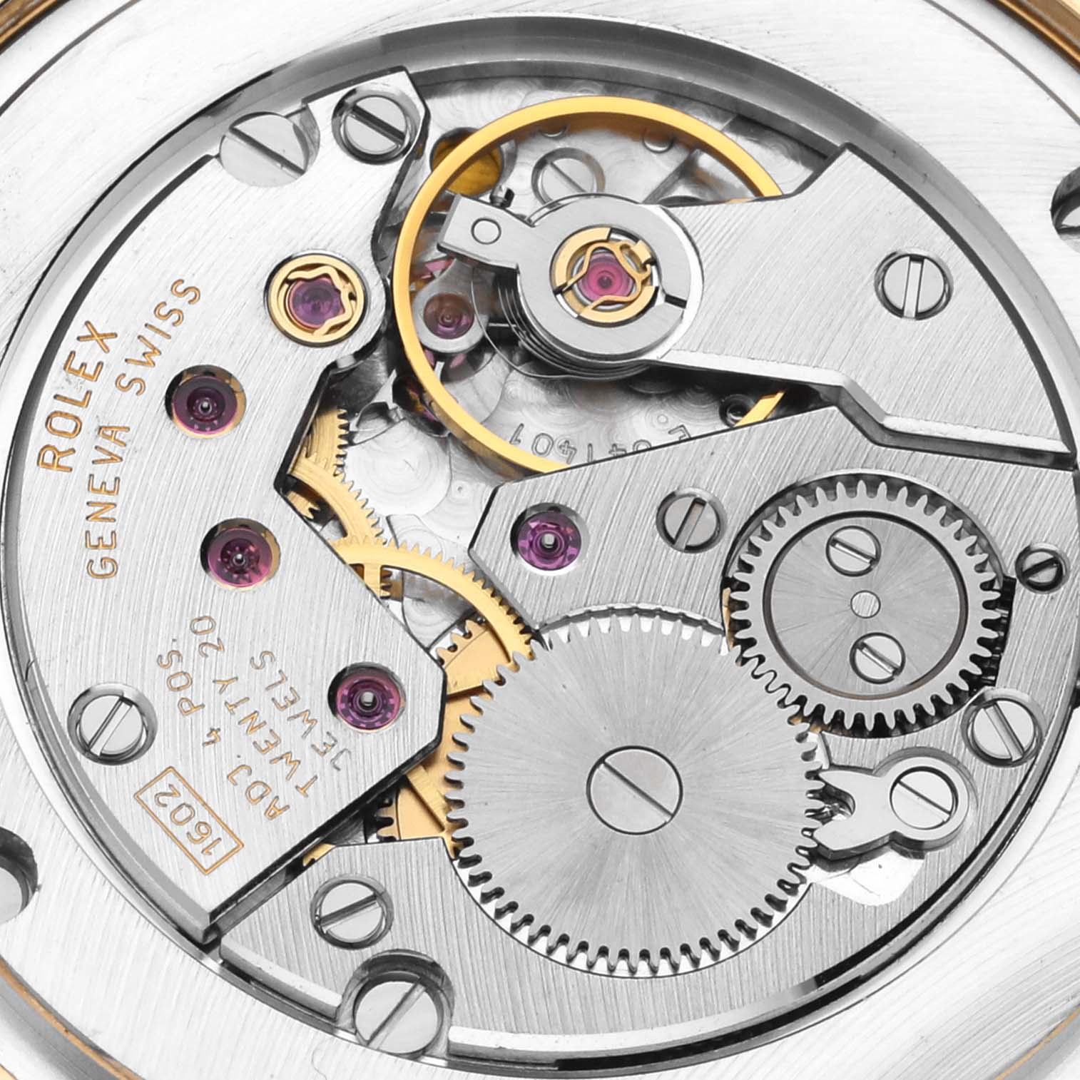 The image shows a close-up view of the movement parts of a Rolex Cellini 5115 Men's Yellow Gold Silver Dial 5115 Men's Yellow Gold Silver Dial watch, including gears and screws.