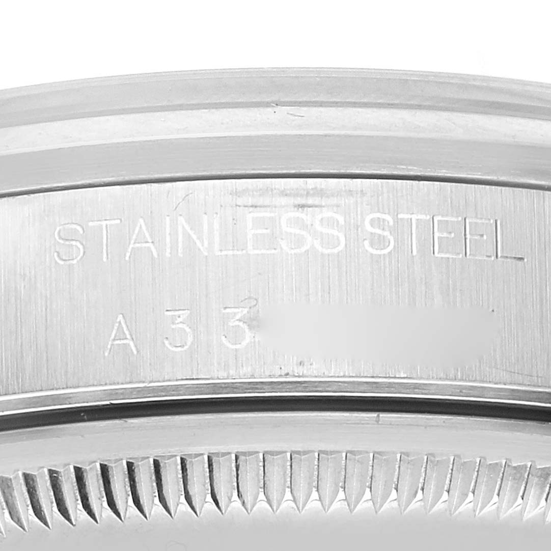 The image shows a close-up of a stainless steel case back with an inscription, belonging to a Rolex Date 15200 Men's Stainless Steel Black Dial 15200 Men's Stainless Steel Black Dial model watch.