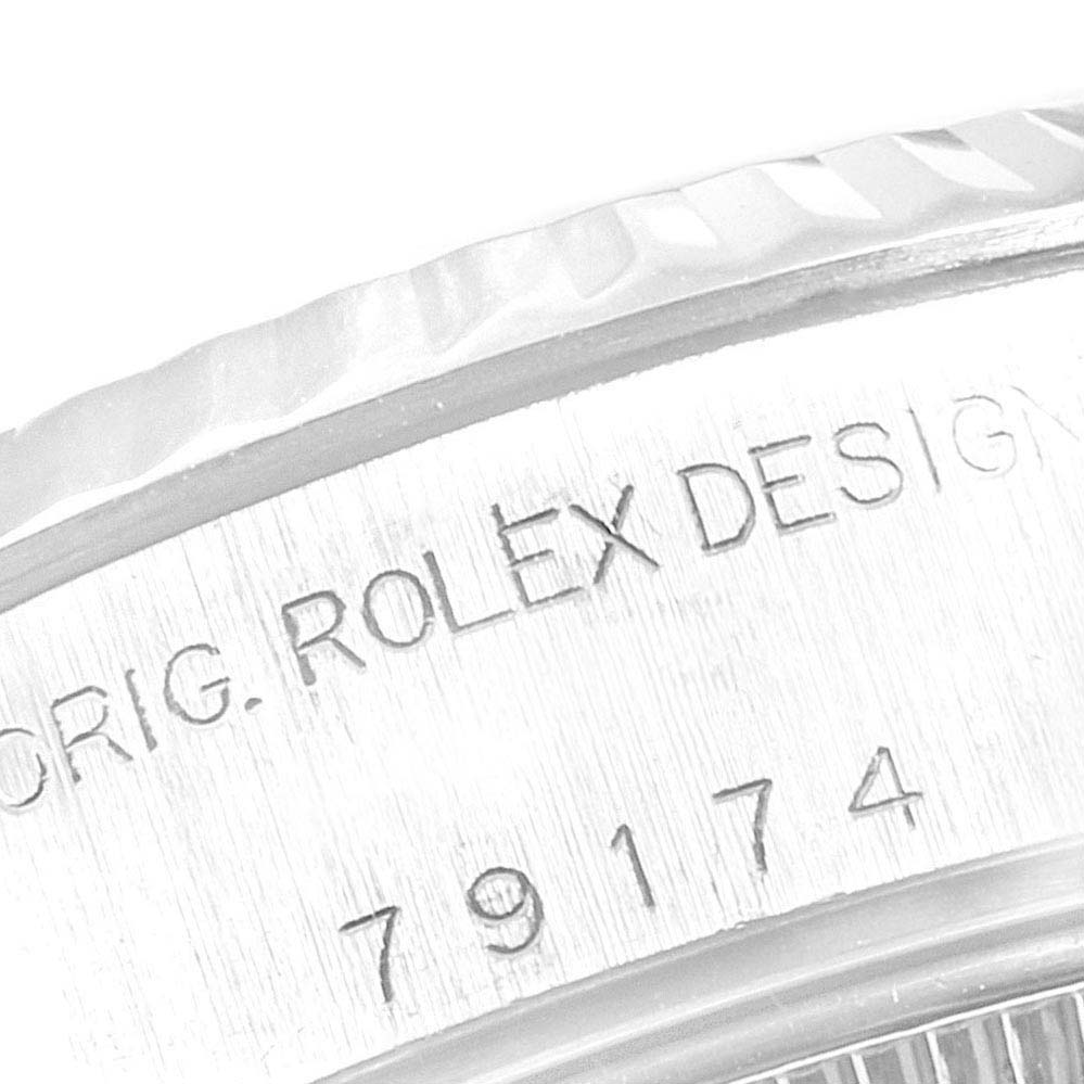 The image shows a close-up of the case side of a Rolex Datejust 79174 Women's Stainless Steel Pink Dial 79174 Women's Stainless Steel Pink Dial, highlighting the engraved model and serial numbers.