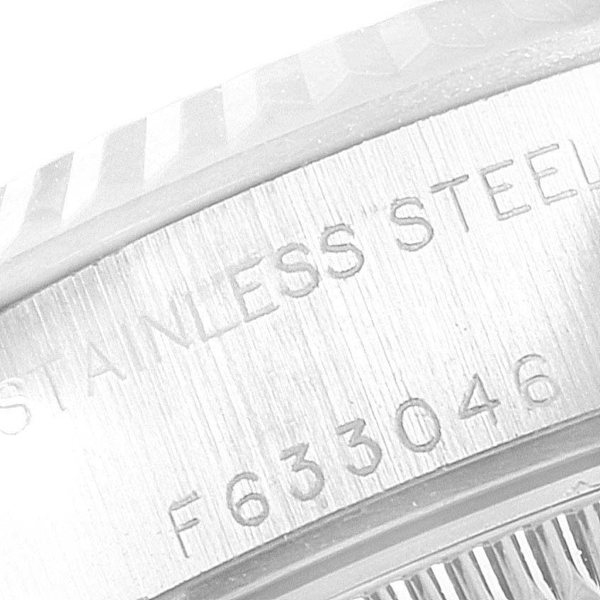The image shows a close-up angle of the outer rim and serial number engraving on a Rolex Datejust 79174 Women's Stainless Steel Pink Dial 79174 Women's Stainless Steel Pink Dial watch.