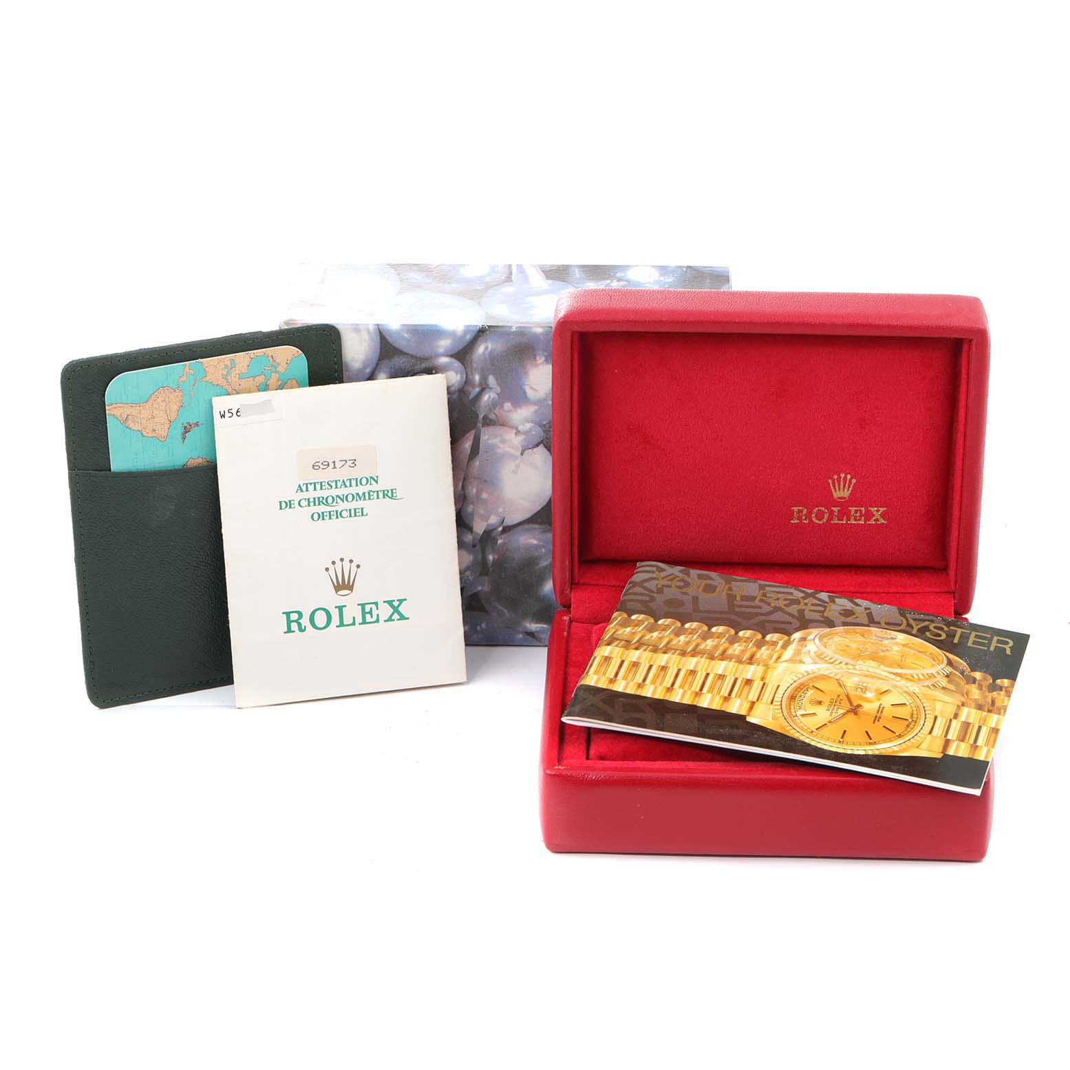 The image shows a Rolex Datejust 69173 Women
s Steel and Gold (two tone) Champagne Dial 69173 Women
s Steel and Gold (two tone) Champagne Dial watch box and accompanying booklets, including a certification document and a product manual.