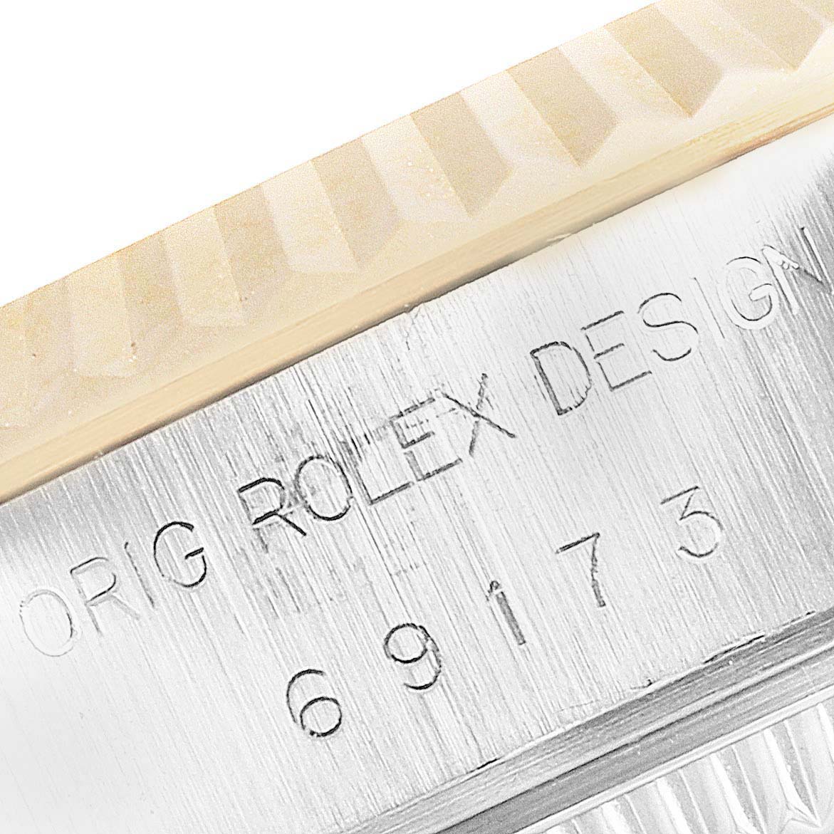 This close-up image shows the engraved inner bezel of a Rolex Datejust 69173 Women
s Steel and Gold (two tone) Champagne Dial 69173 Women
s Steel and Gold (two tone) Champagne Dial watch, highlighting the model number and "ROLEX DESIGN" text.