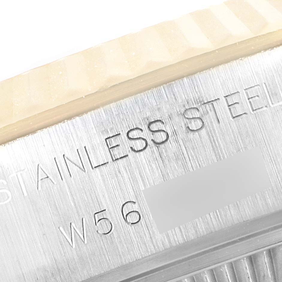 This close-up image displays the side of the bezel and the case of a Rolex Datejust 69173 Women
s Steel and Gold (two tone) Champagne Dial 69173 Women
s Steel and Gold (two tone) Champagne Dial, showing the "Stainless Steel" engraving.