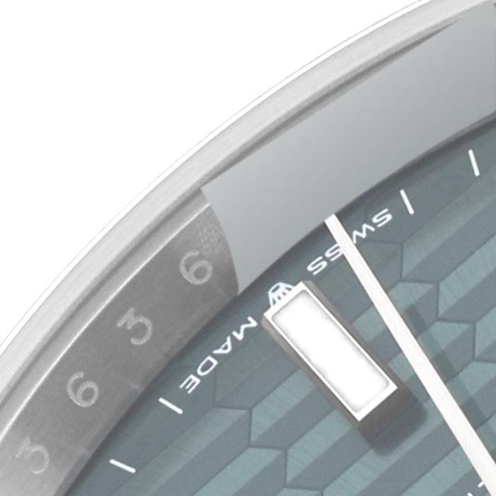 This close-up image of the Rolex Datejust 41 126300 Men's Stainless Steel Green Dial 126300 Men's Stainless Steel Green Dial shows part of the dial, including the numbers and markers.