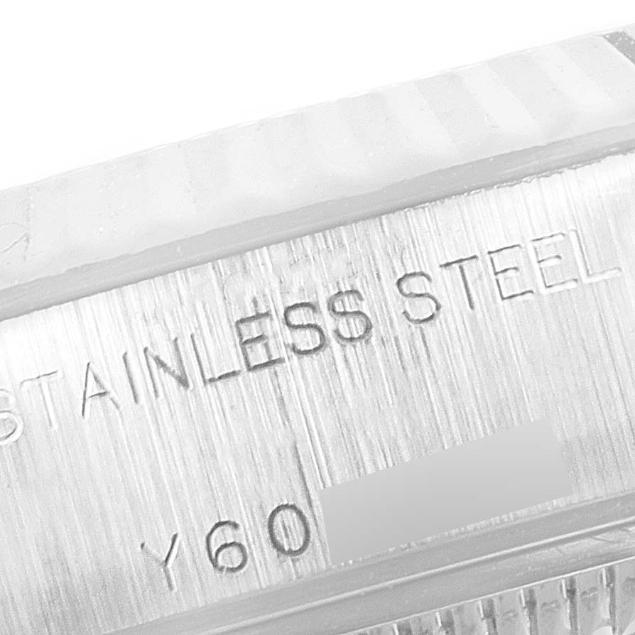 The image shows a close-up of the case edge of a Rolex Datejust 79174 Women
s Stainless Steel Mother of Pearl Dial 79174 Women
s Stainless Steel Mother of Pearl Dial, featuring engraved text indicating "STAINLESS STEEL".