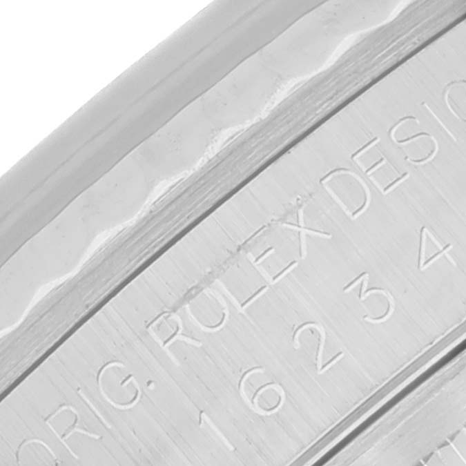 The image shows a close-up of the inner rim with engraved text on a Rolex Datejust 16234 Men's Stainless Steel Black Dial 16234 Men's Stainless Steel Black Dial watch.