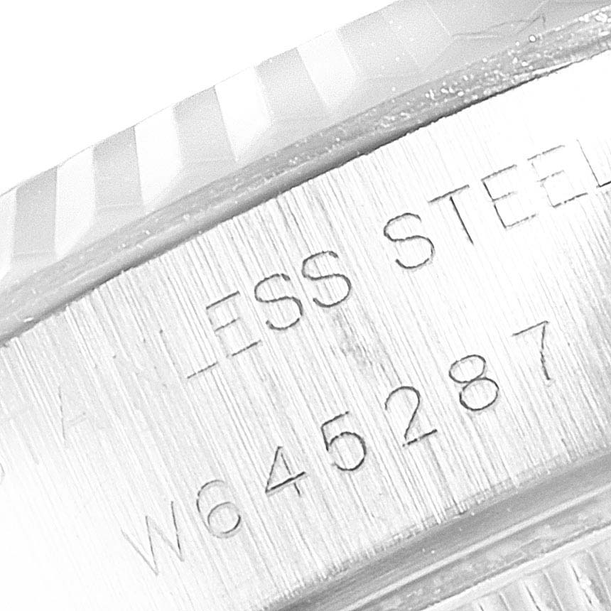 The image shows a close-up of the serial number and stainless steel engraving on the side of a Rolex Datejust 69174 Women
s Stainless Steel Silver Dial 69174 Women
s Stainless Steel Silver Dial watch case.
