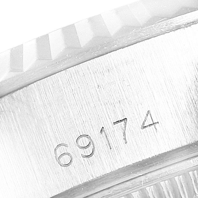 The image shows a close-up of the case side of a Rolex Datejust 69174 Women
s Stainless Steel Silver Dial 69174 Women
s Stainless Steel Silver Dial watch, revealing the model number "69174" engraved on it.