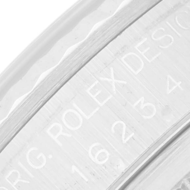 This close-up image shows the engraved bezel portion of a Rolex Datejust 16234 Men's Stainless Steel White Dial 16234 Men's Stainless Steel White Dial watch.